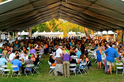 Over 600 wine lovers dining under a big tent and gigantic chandelier at Vintners Grille 