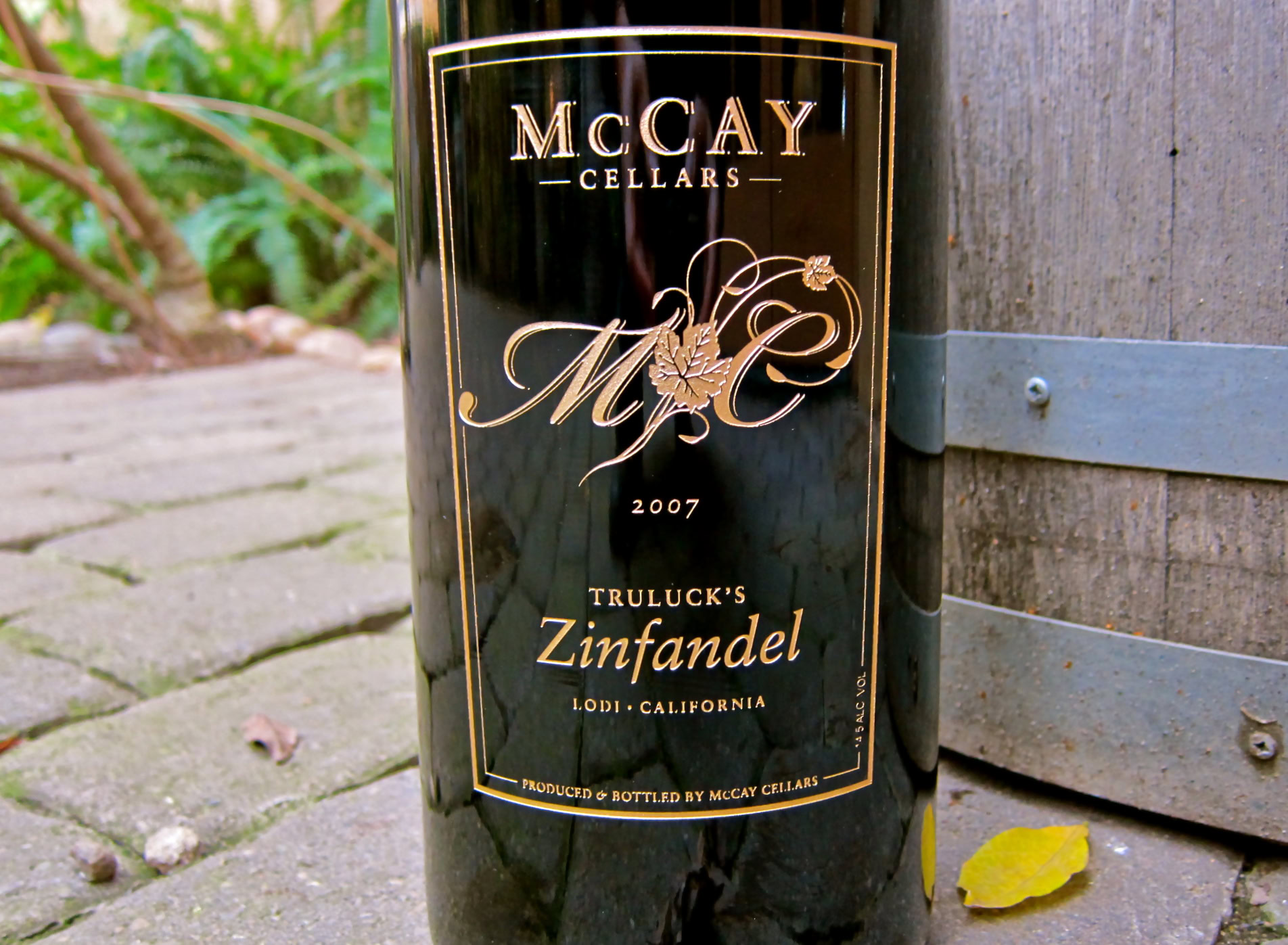 Lodi Zinfandel wine bottle from McCay Cellars, California, with vineyard background.