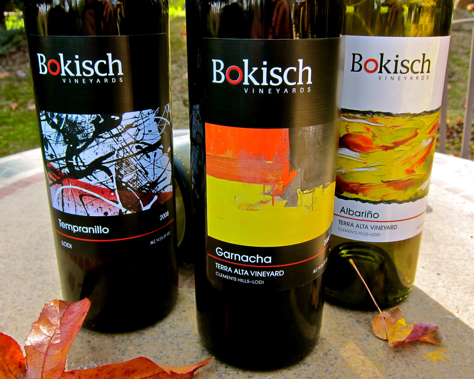 Three Bokisch Vineyards wine bottles featuring Tempranillo, Garnacha, and Albariño with colorful labels.