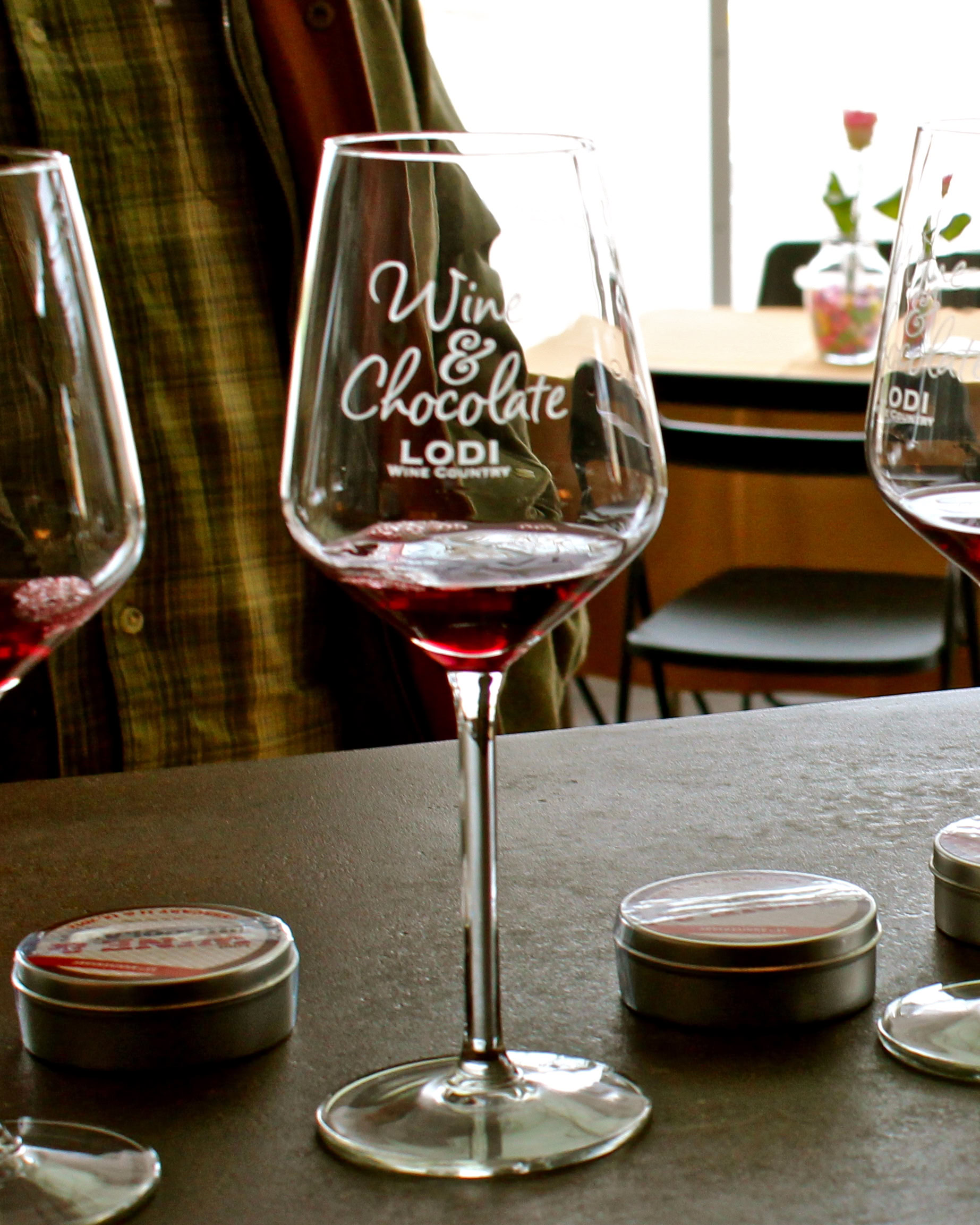 A wine glass with 'Wine & Chocolate Lodi' text, showcasing Lodi wine culture and wine tasting experience.