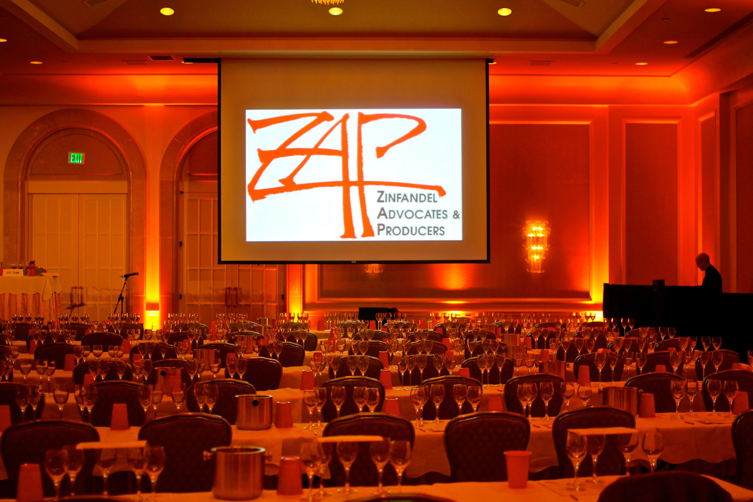 Conference room with round tables, projection screen, and warm lighting for Lodi Winegrape Commission event.