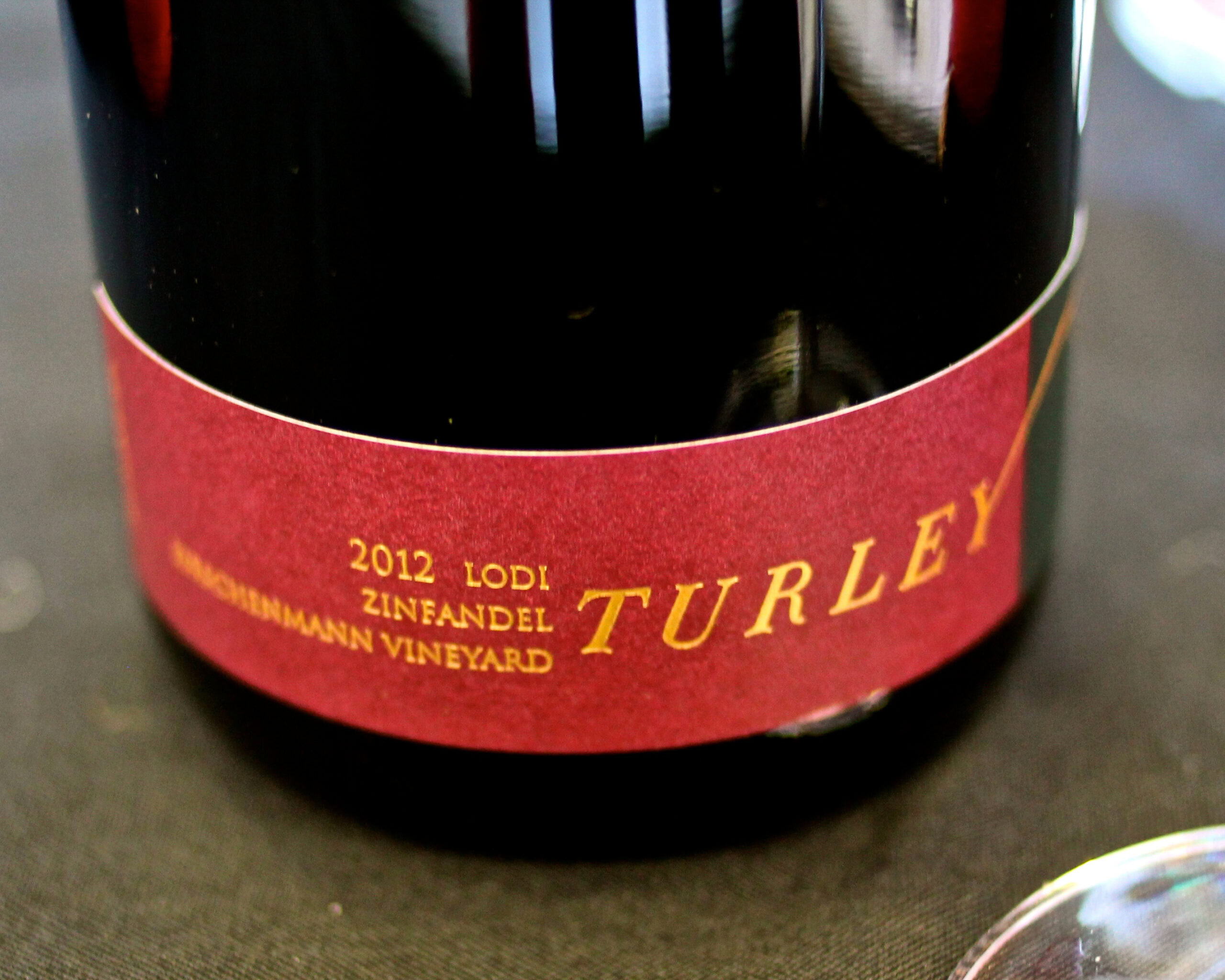 Close-up of 2012 Lodi Zinfandel wine bottle label from Turley, showcasing vineyard details and vintage year.