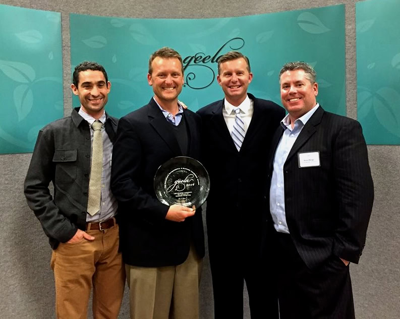Group of four men at Lodi Winegrape Commission event, one holding an award, smiling for the camera.