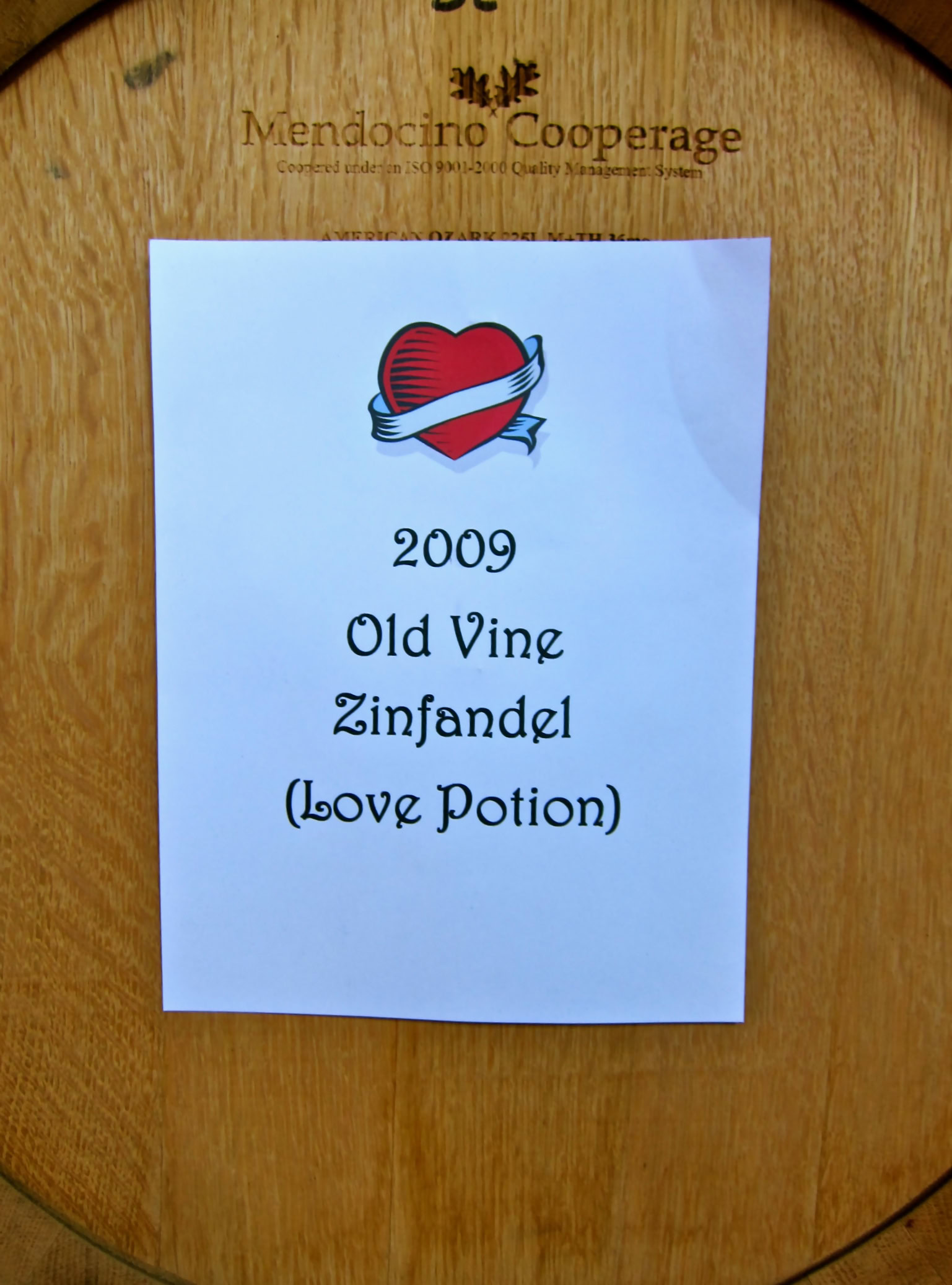 2009 Old Vine Zinfandel Love Potion wine label on wooden barrel.