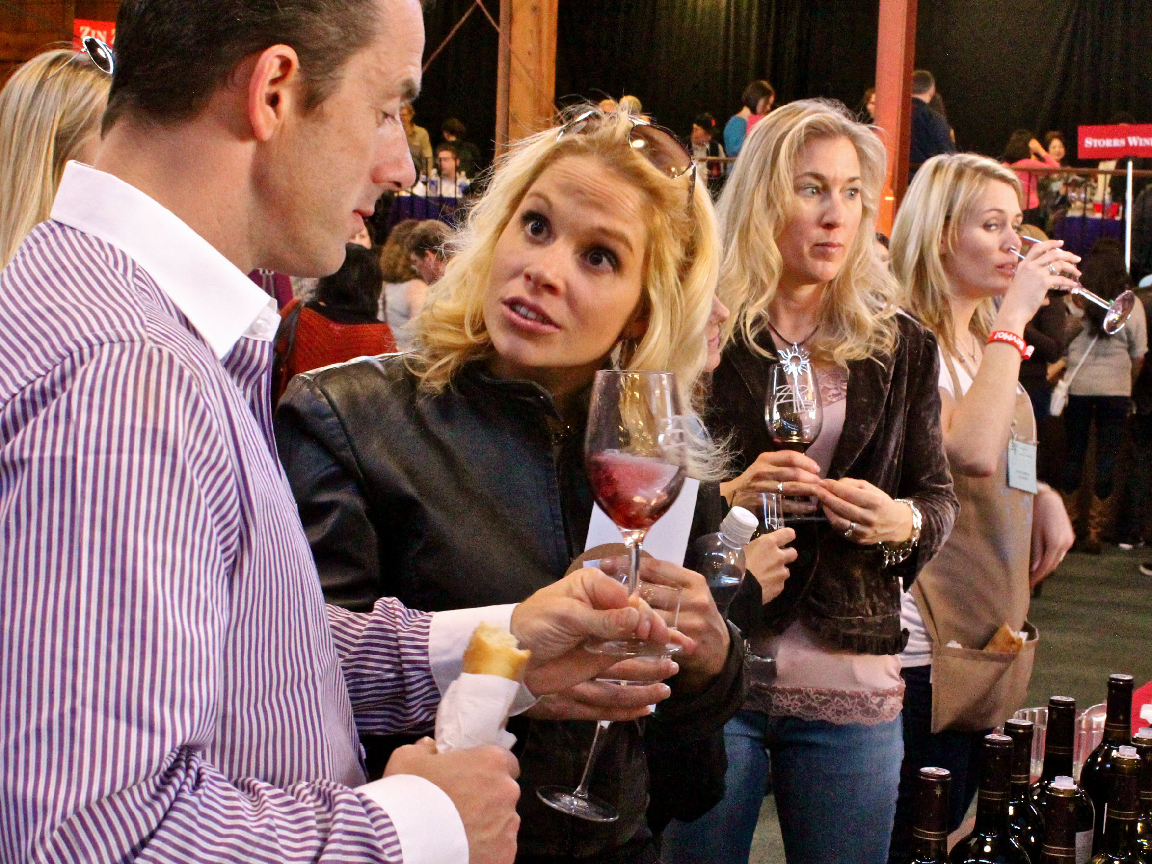 People tasting wine at a Lodi Winegrape Commission event, showcasing local wines and wine culture.