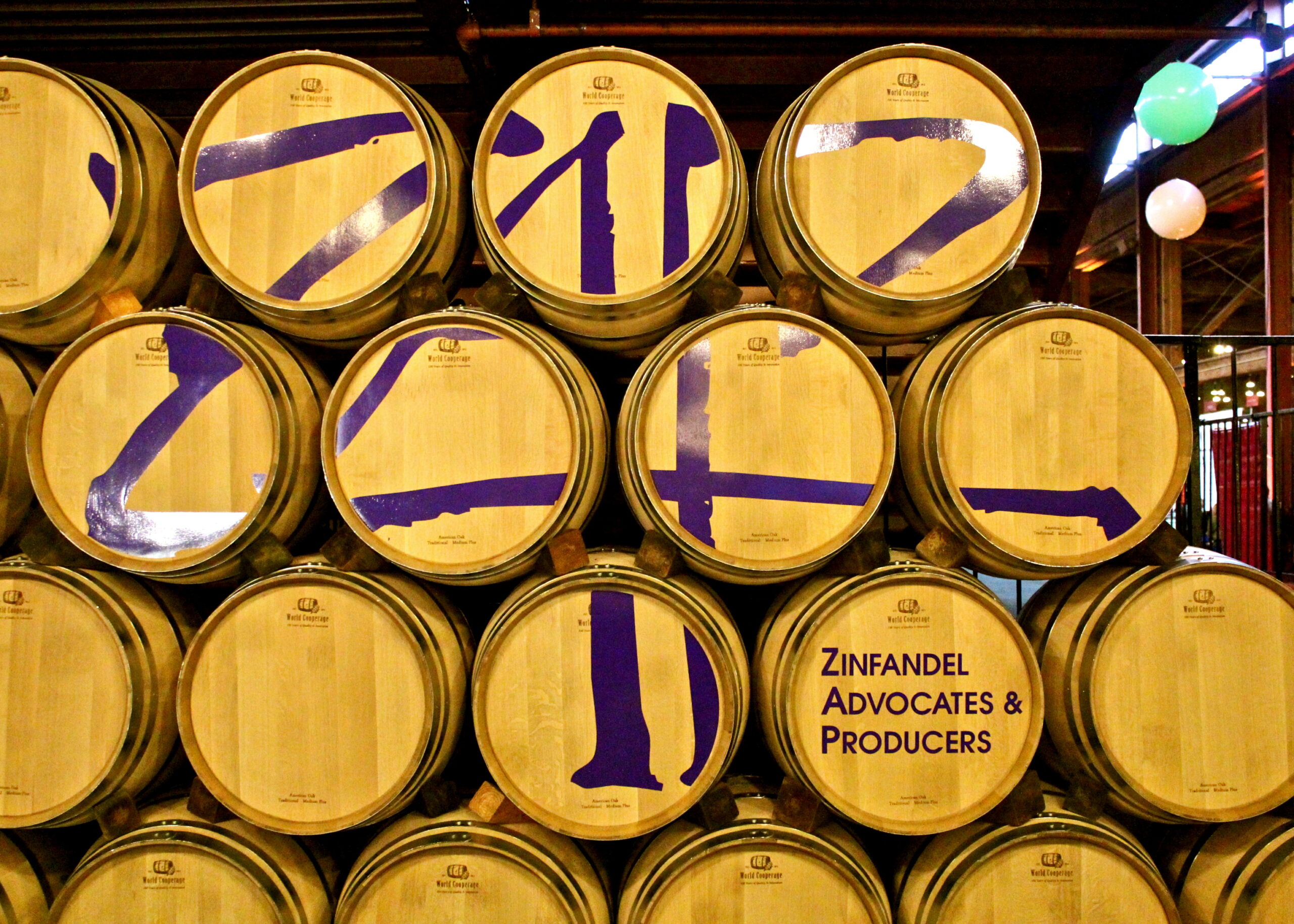 Wine barrels with purple numbers and a Zinfandel sign at Lodi Winegrape Commission.