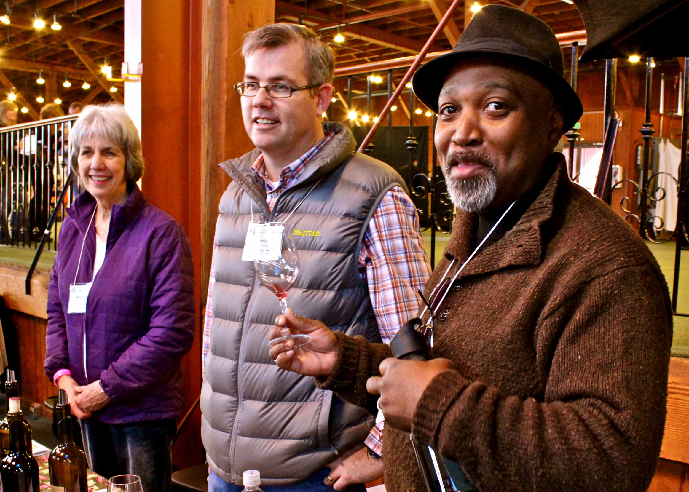 People enjoying wine tasting at Lodi Winegrape Commission event, showcasing local wines and vibrant atmosphere.