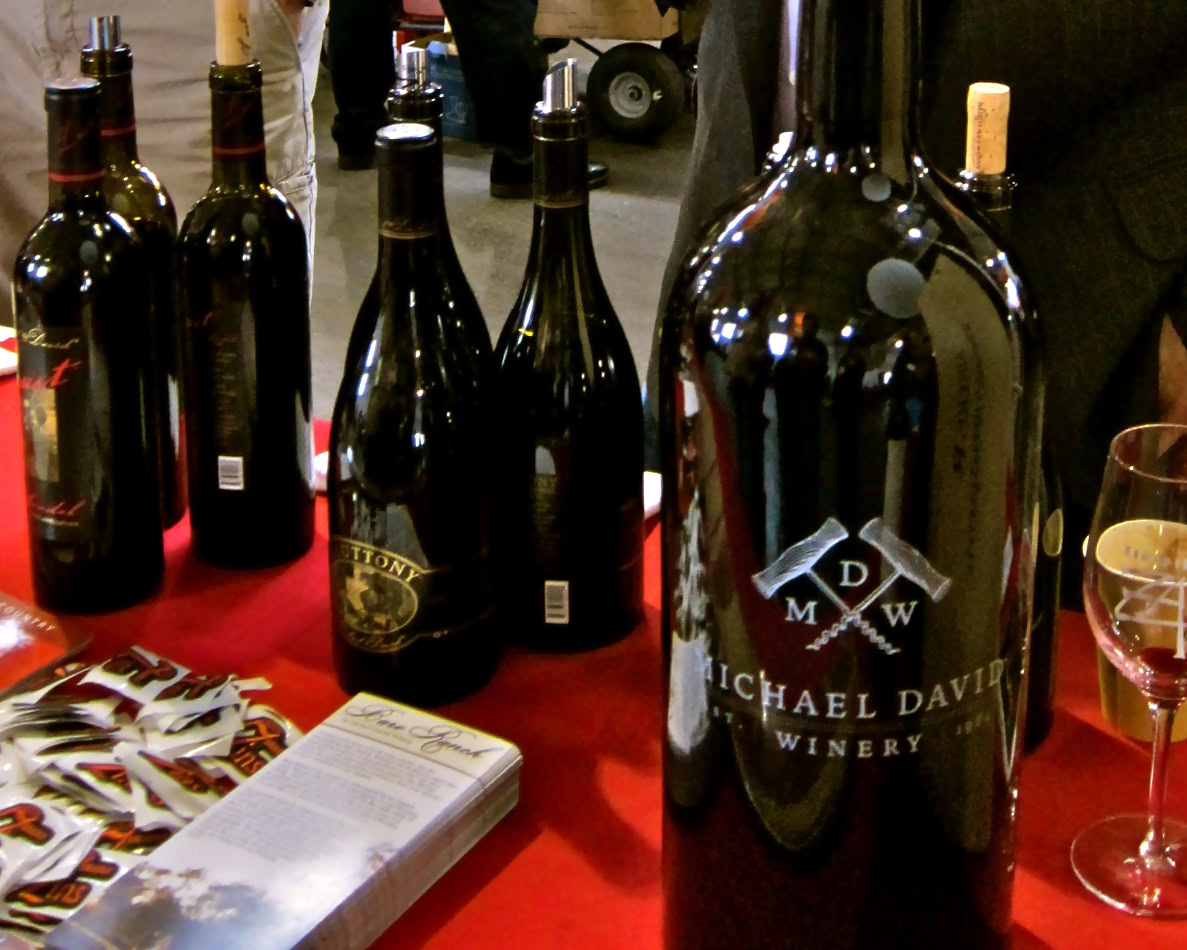 Wine bottles from Lodi Winegrape Commission at a tasting event, showcasing local wine production.