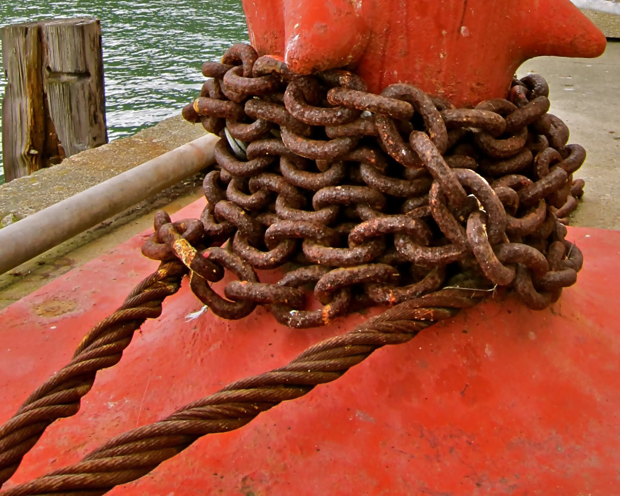 Close-up of rusty chain and anchor at Lodi waterfront, California, emphasizing maritime and agricultural heritage.