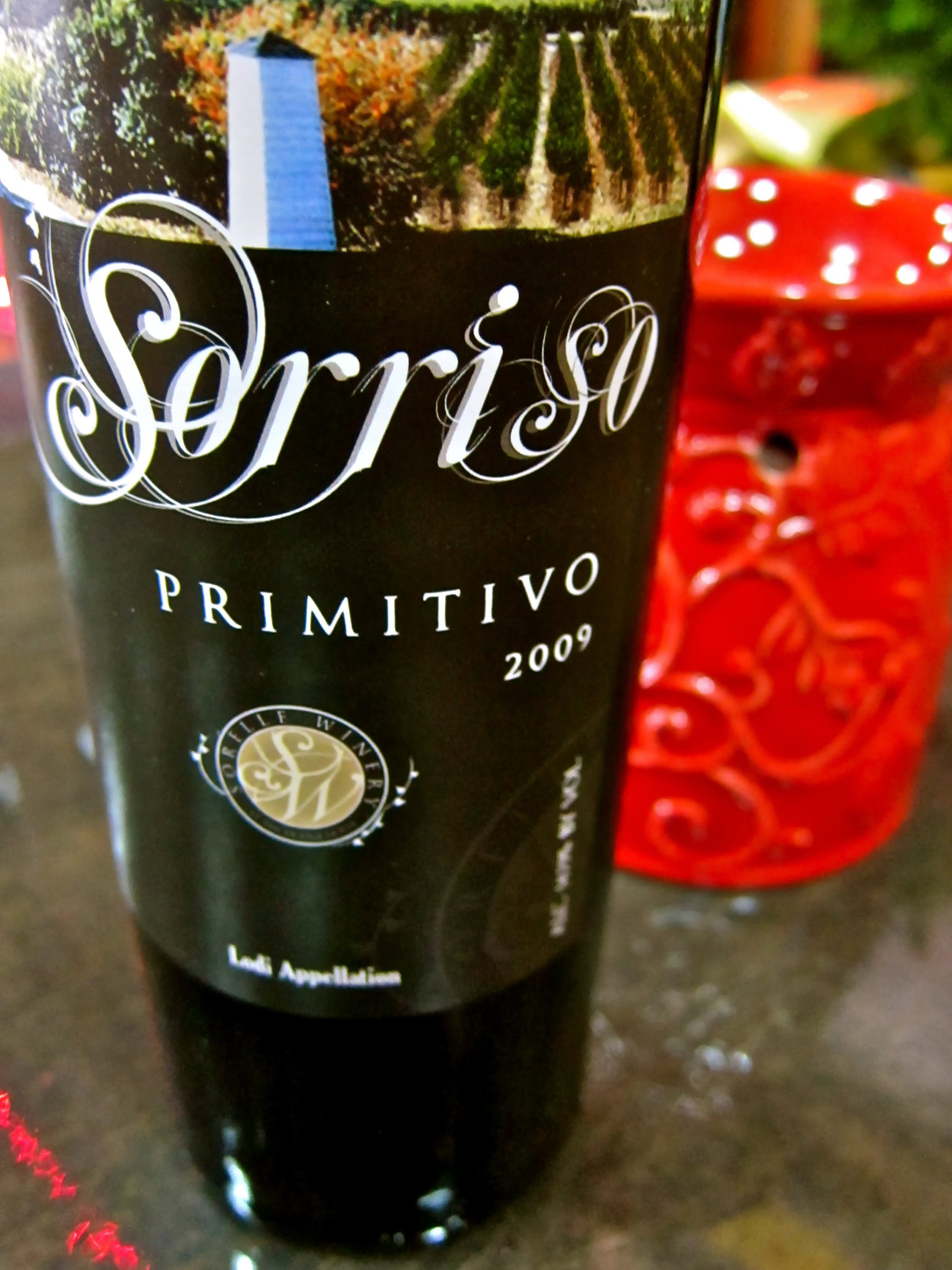 Close-up of Sorriso Primitivo 2009 wine bottle from Lodi Winegrape Commission, showcasing elegant label design.