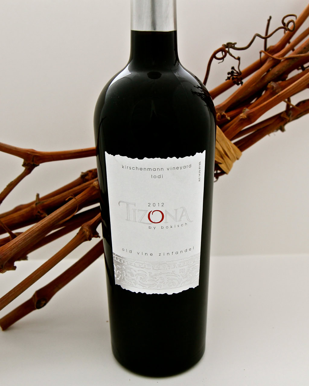 Bottle of Tizona 2012 wine from Lodi Winegrape Commission with grapevine in background.