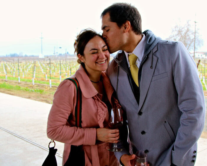 Couple enjoying wine tasting at Lodi Winegrape Commission vineyard in California.