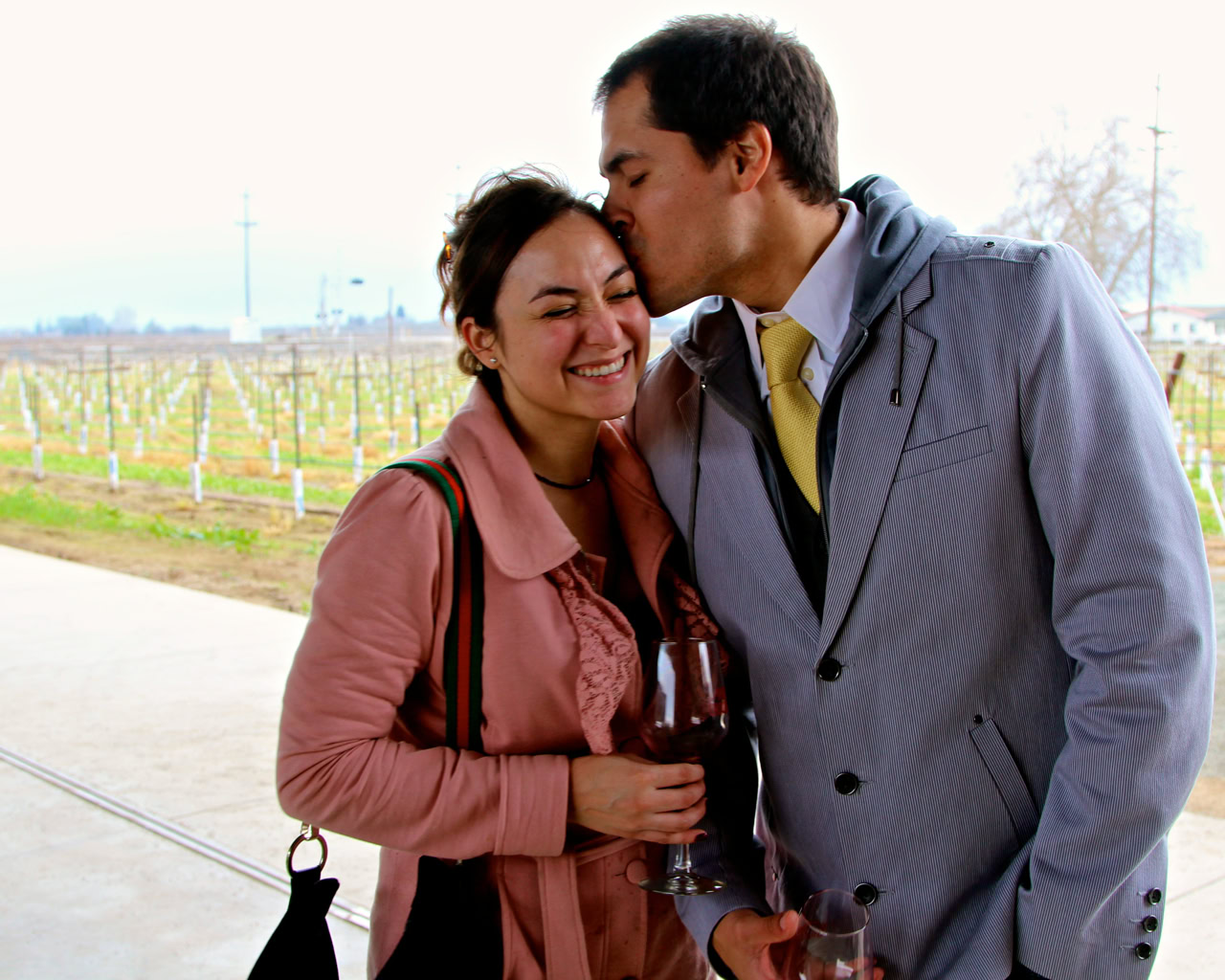 Couple enjoying wine tasting at Lodi Winegrape Commission vineyard in California.