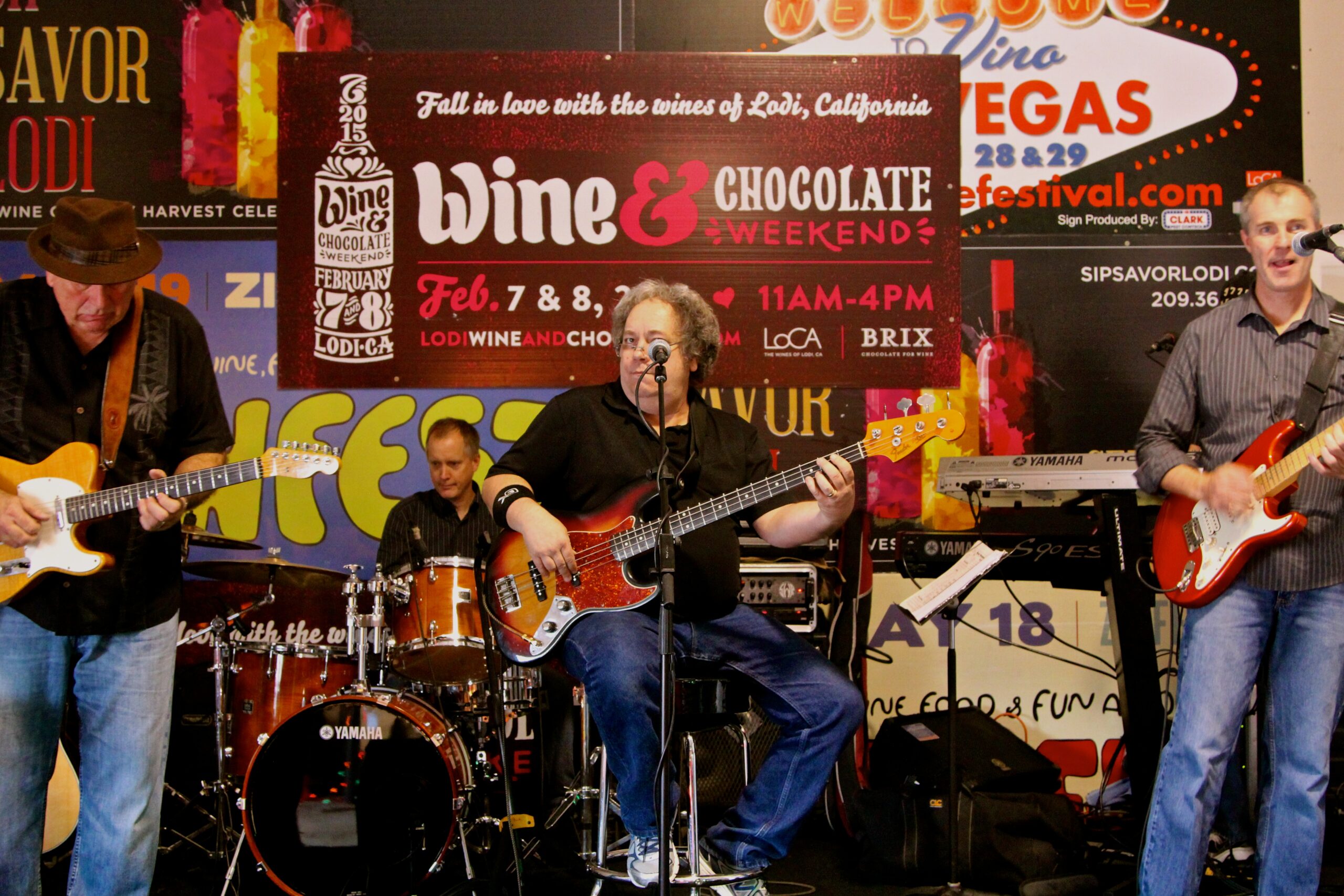 Live band performing at the Lodi Winegrape Commission event in California with colorful banners in the background.
