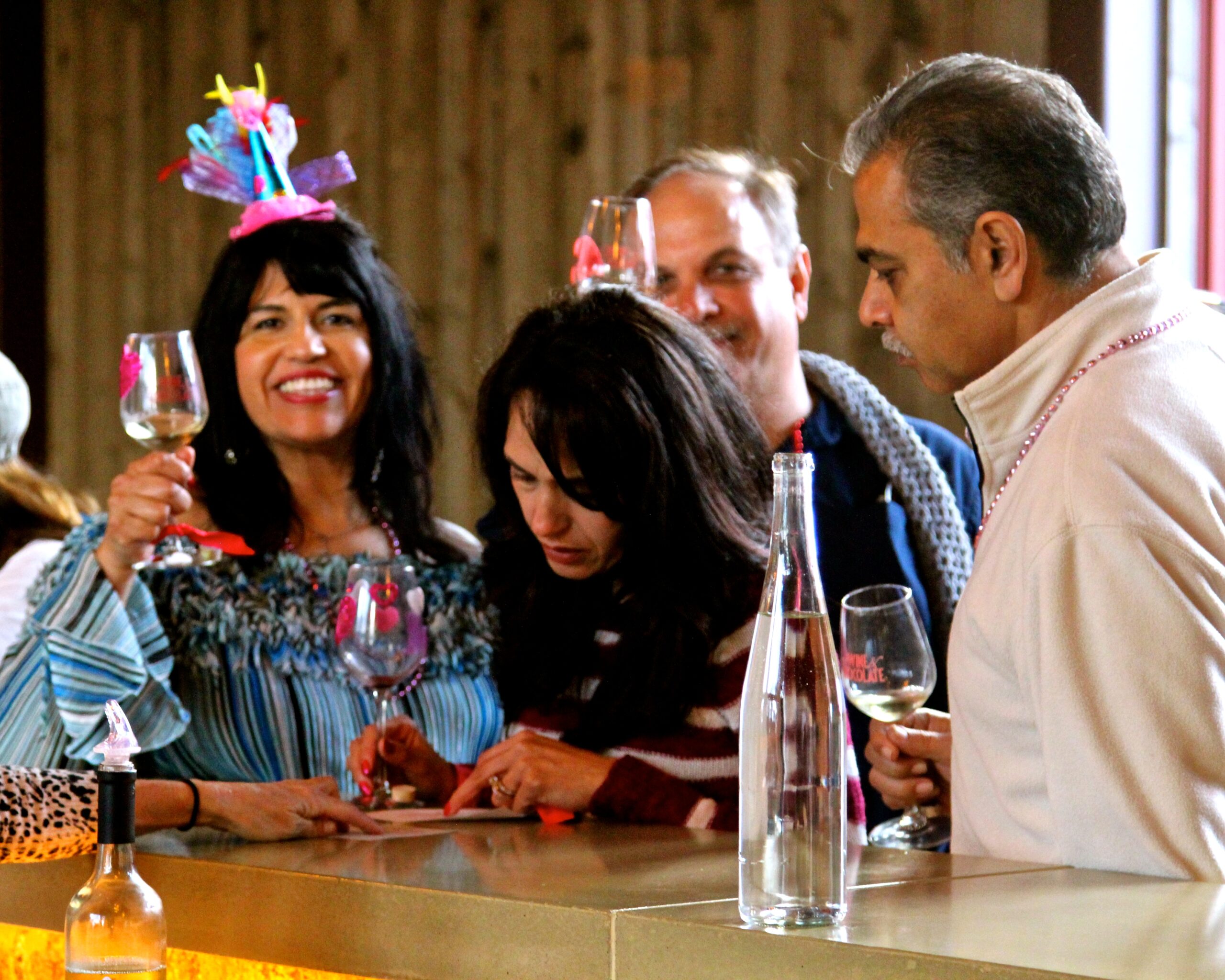 Group of people enjoying wine tasting at Lodi Winegrape Commission event.