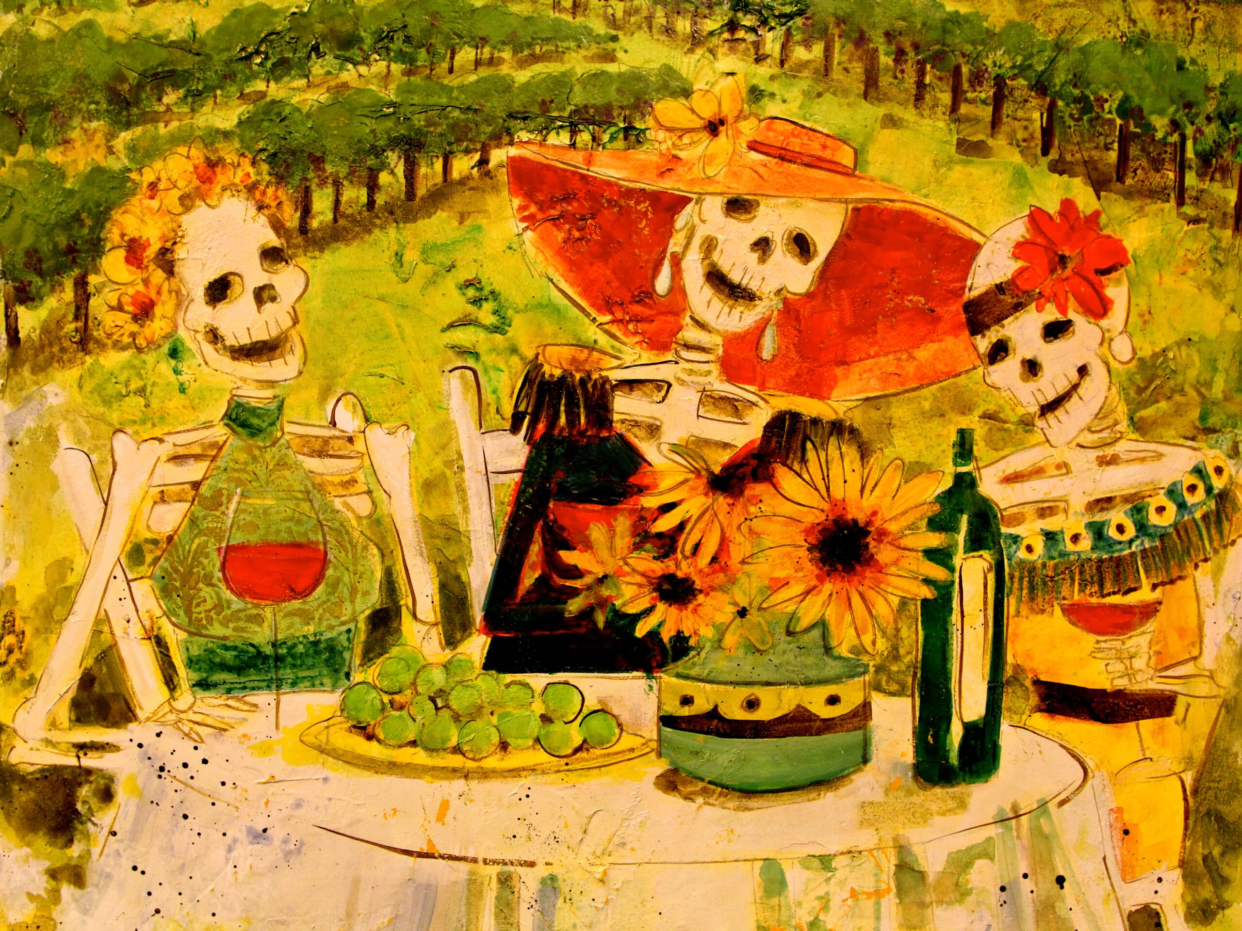 Skeletons enjoying a festive outdoor meal with wine, flowers, and a vineyard background.