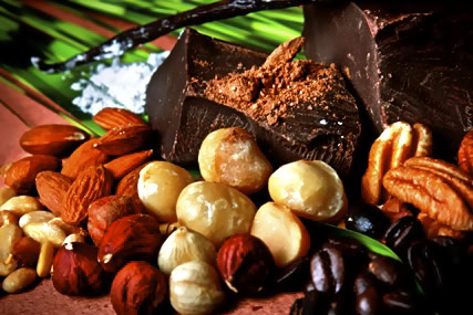 Chocolate, nuts, and dried fruits arranged with green leaves for Lodi Winegrape Commission.