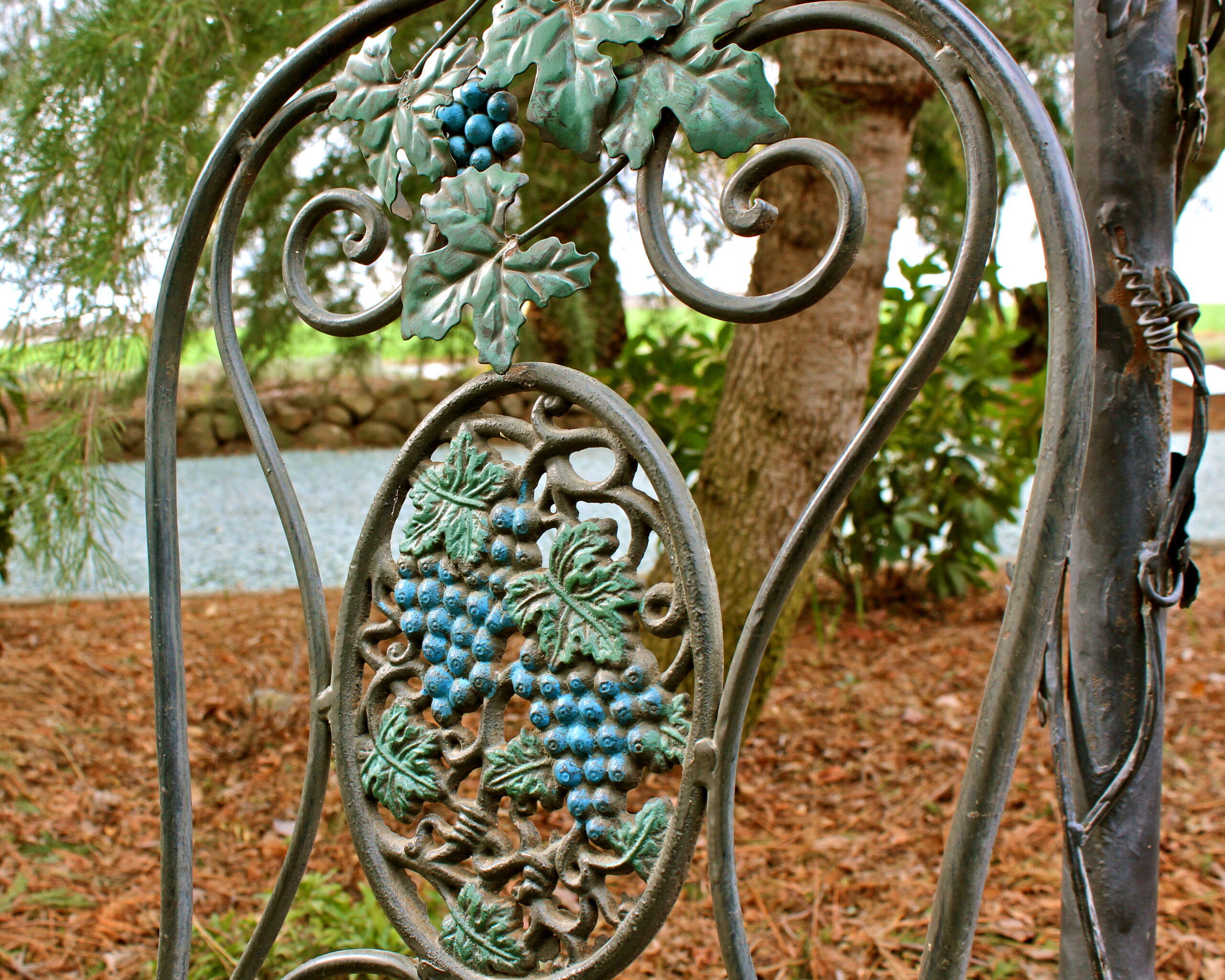 Ornamental metal sculpture featuring grape clusters and leaves, symbolizing viticulture and wine culture.