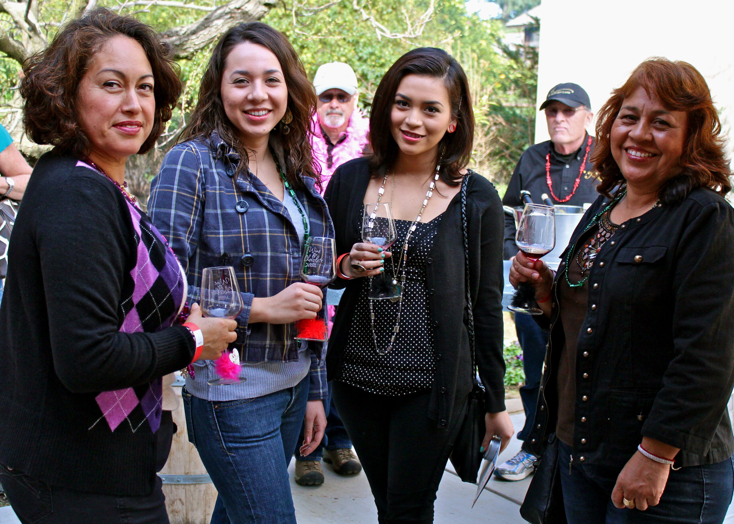 Group of women enjoying wine tasting outdoors at a Lodi Winegrape Commission event.