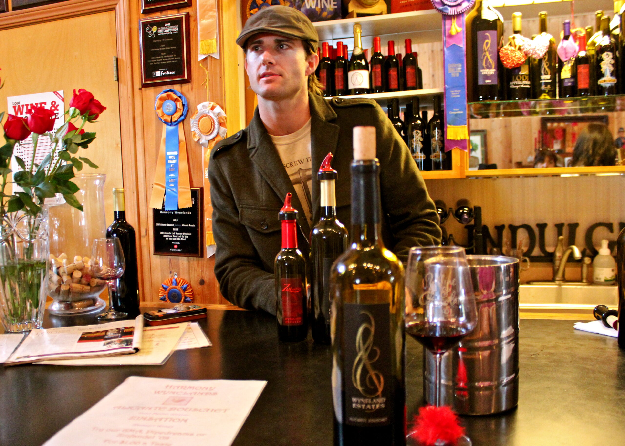 Wine tasting at Lodi Winegrape Commission with bottles and glasses on the table.