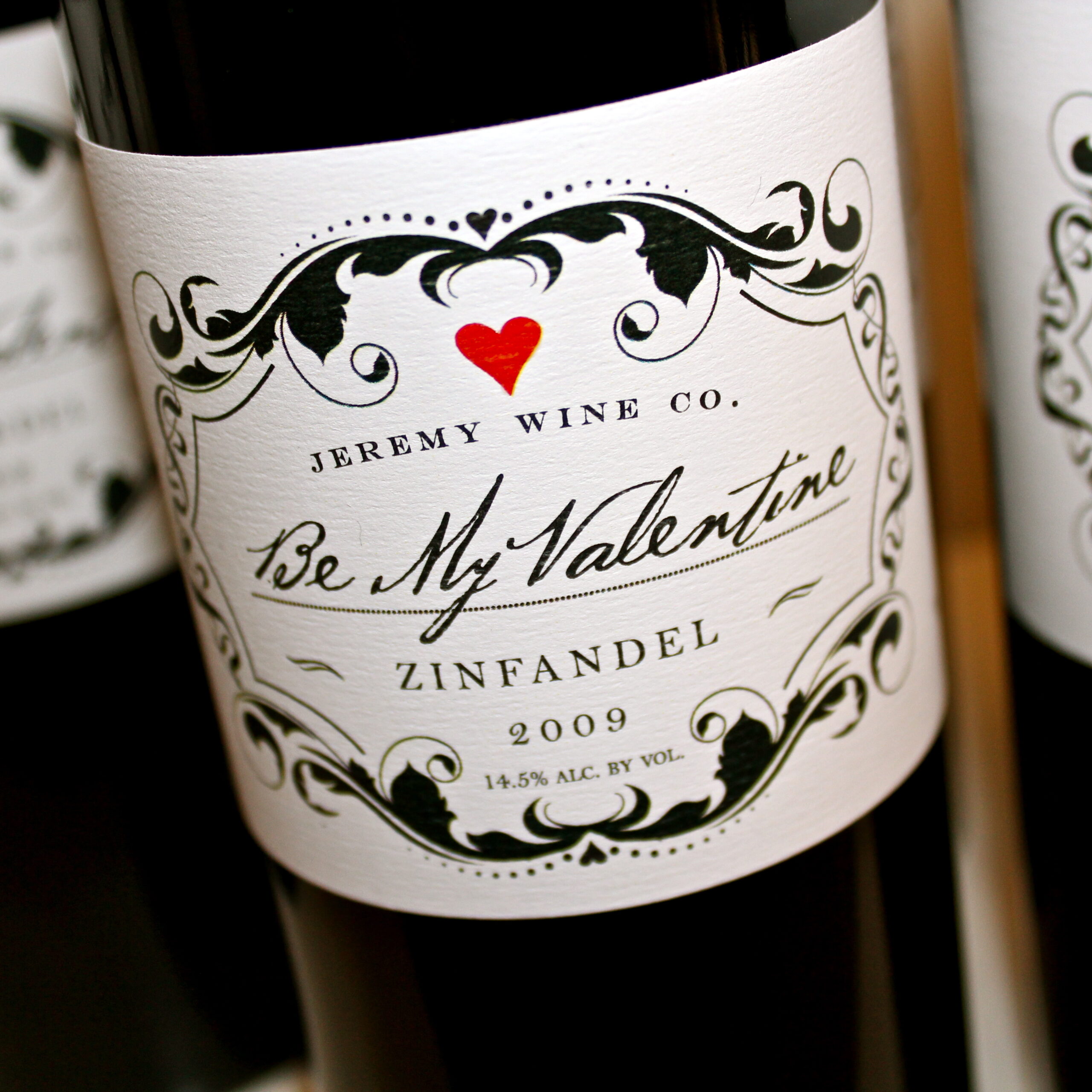 Close-up of a wine bottle label from Jeremy Wine Co. featuring Zinfandel 2009 with Valentine's Day theme.