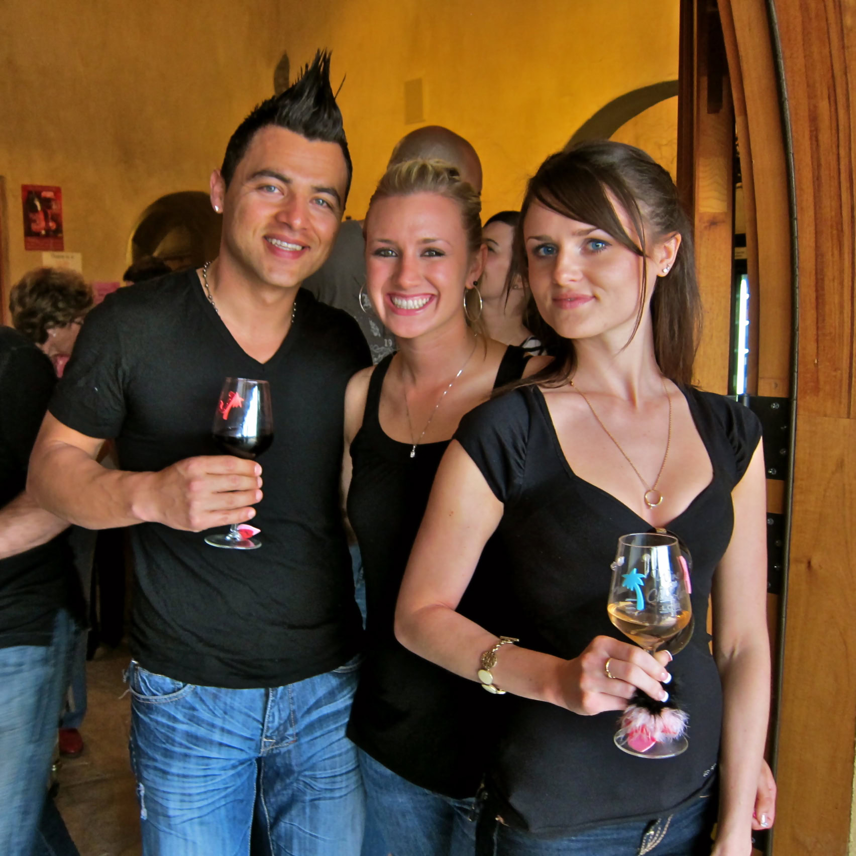 Group of people enjoying wine at a Lodi Winegrape Commission event.