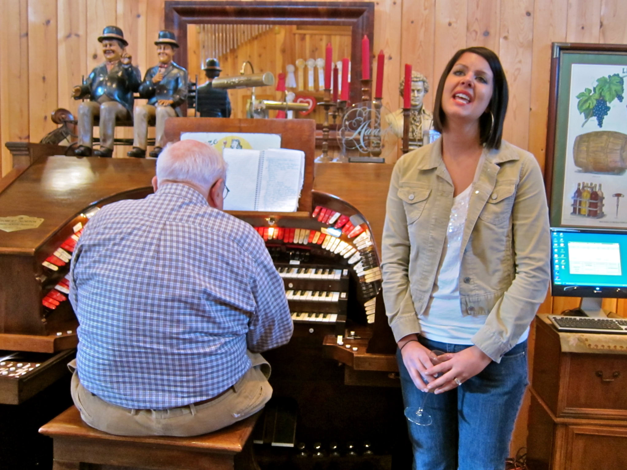 Woman singing and man playing piano at Lodi Winegrape Commission event.