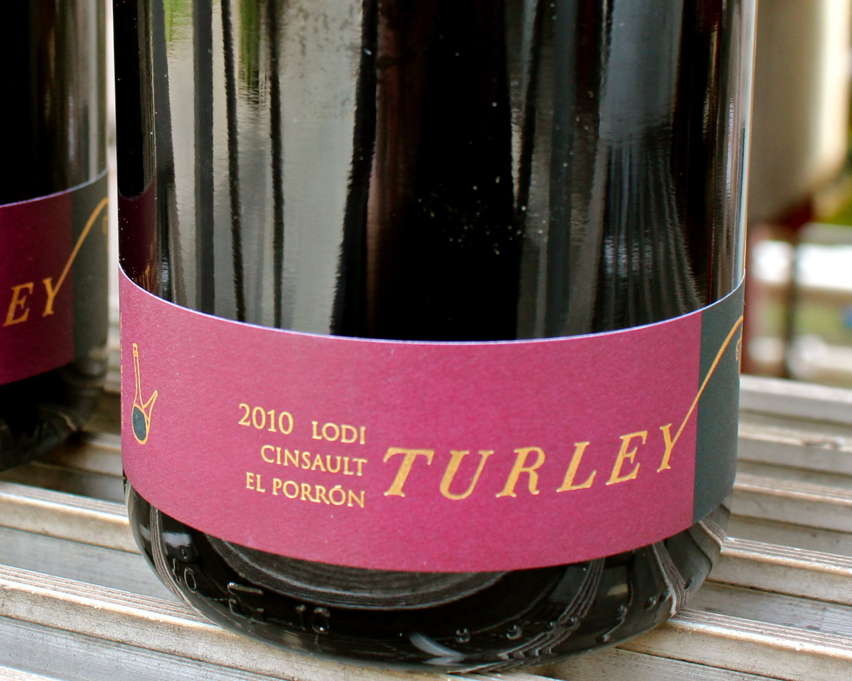 Close-up of a 2010 Turley Lodi wine bottle with pink label on a wine rack.