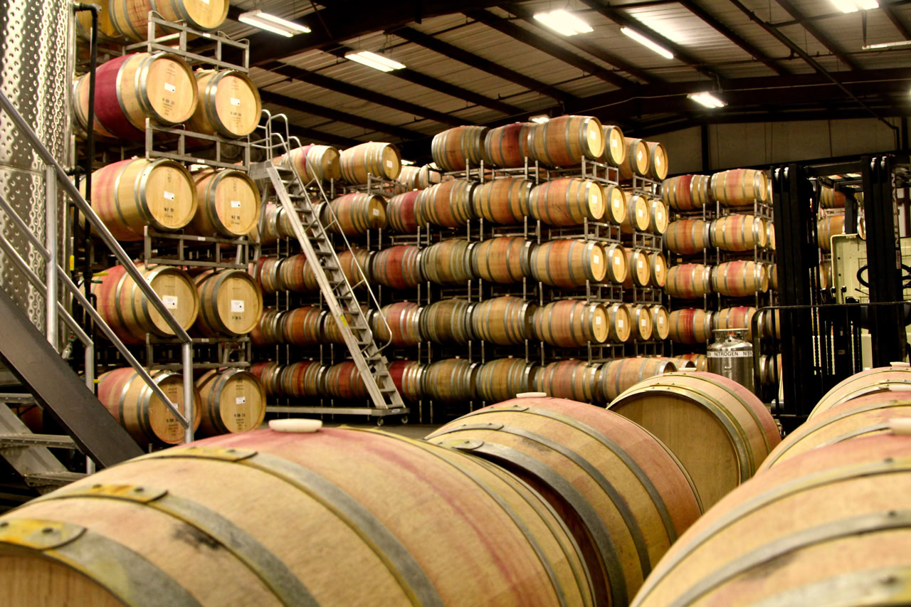 Wine barrels stored in a winery warehouse for aging and fermentation in Lodi, California.