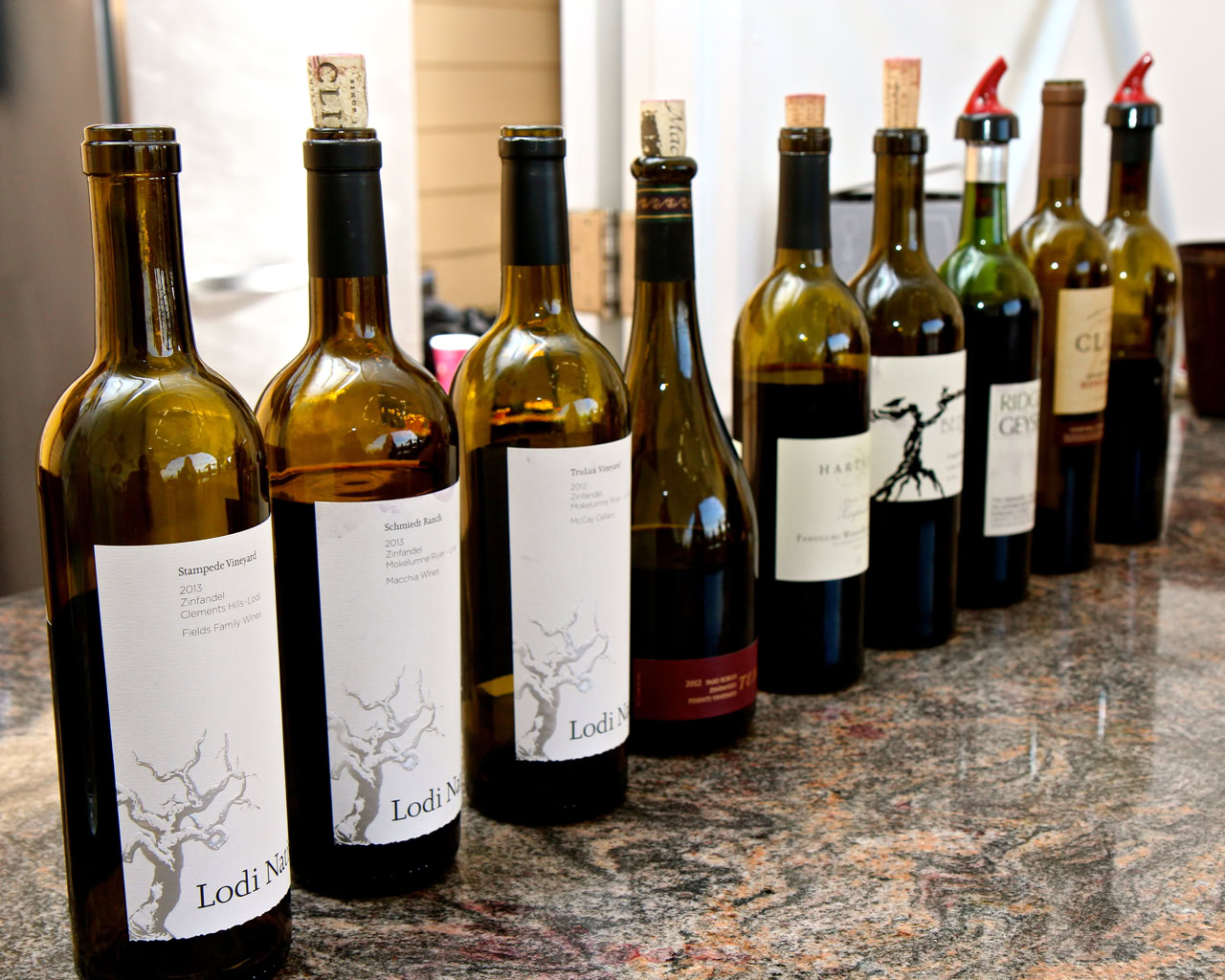 Collection of wine bottles from the Lodi Winegrape Commission showcasing local wine varieties.