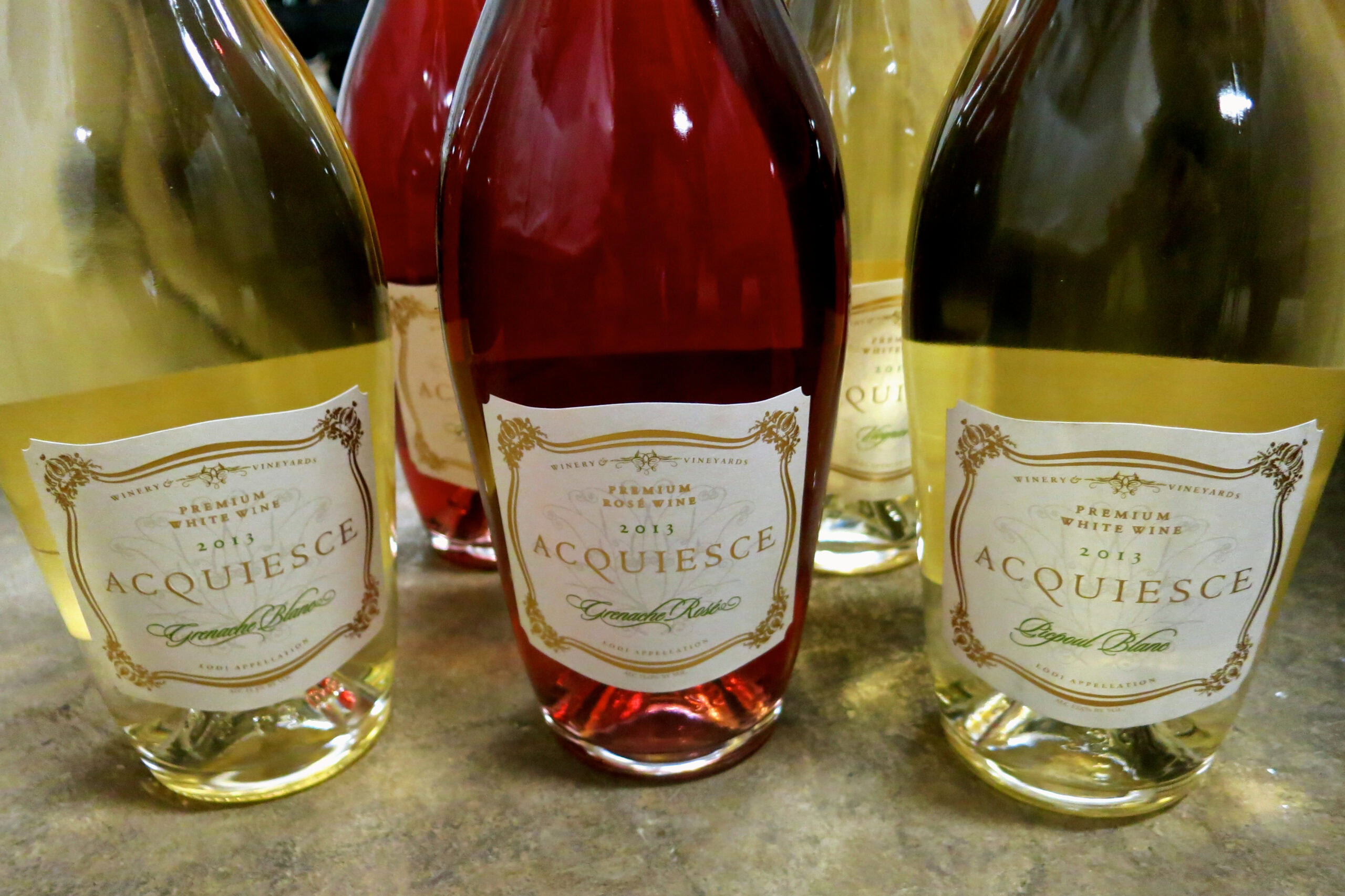 Assorted bottles of wine from the Lodi Winegrape Commission, showcasing different varieties and colors.