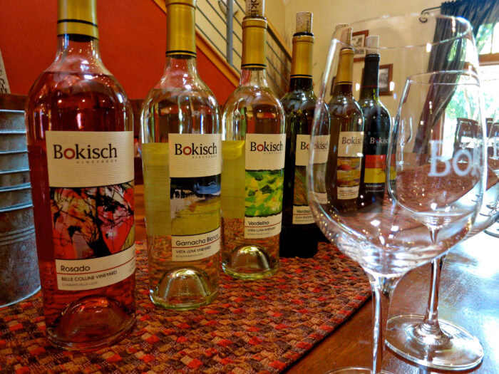 Collection of Bokisch wine bottles from Lodi Winegrape Commission on a table with wine glasses.