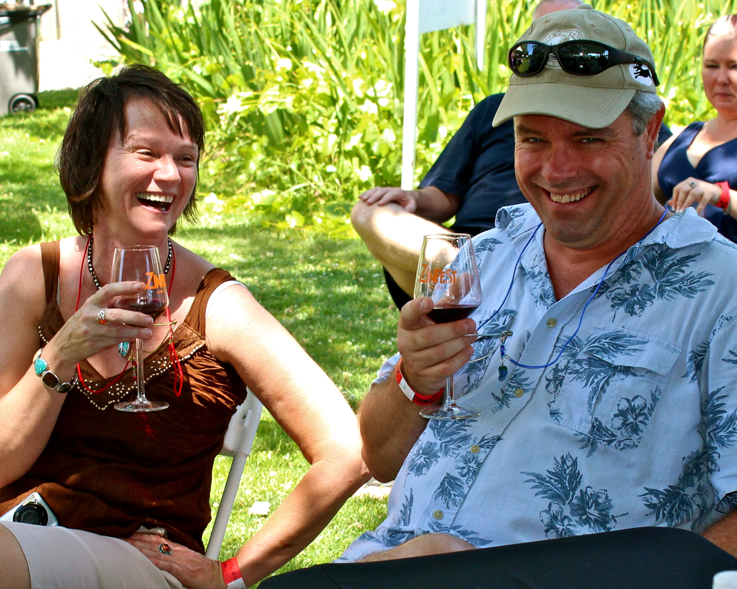 People enjoying wine tasting outdoors at a Lodi Winegrape Commission event.
