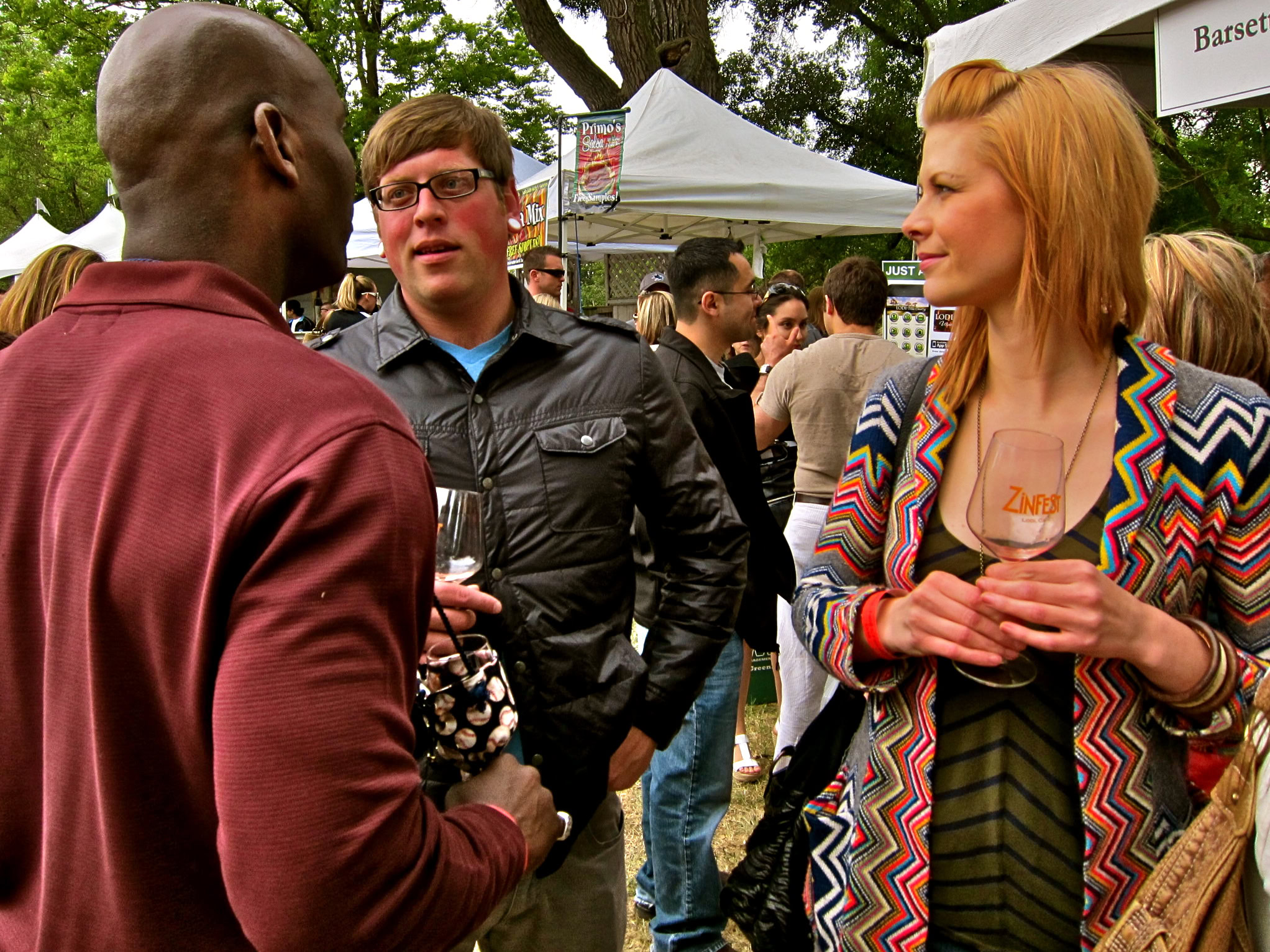 People enjoying wine tasting at a Lodi Winegrape Commission outdoor event.