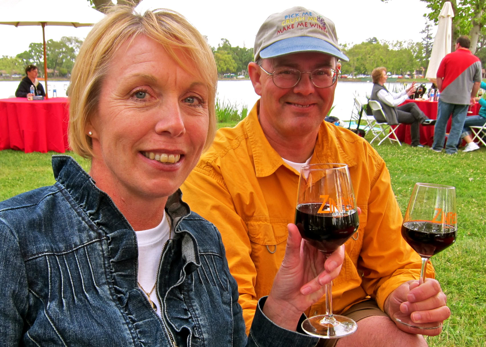 Smiling couple enjoying wine tasting outdoors at Lodi Winegrape Commission event.