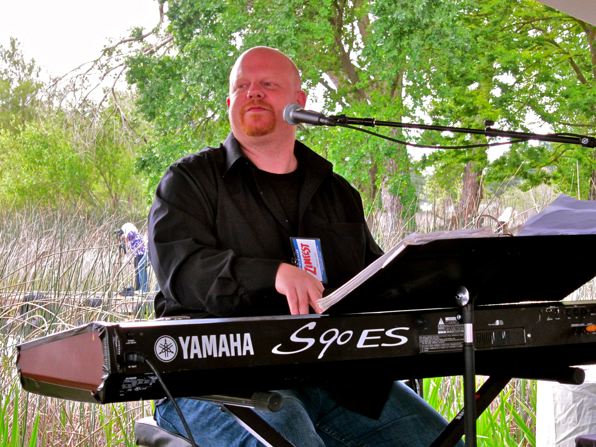 Man playing Yamaha keyboard outdoors at Lodi Winegrape Commission event.