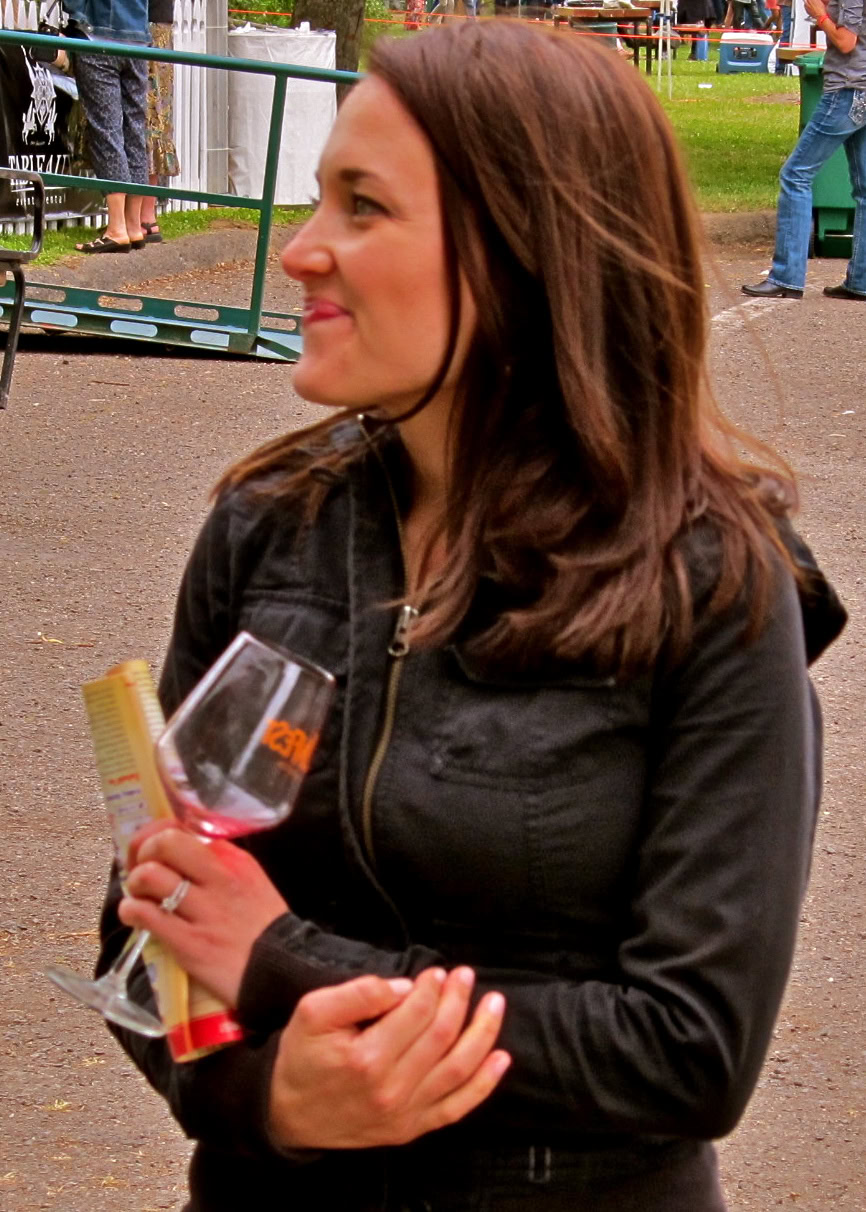 Woman holding a glass of red wine at a Lodi Winegrape Commission event.