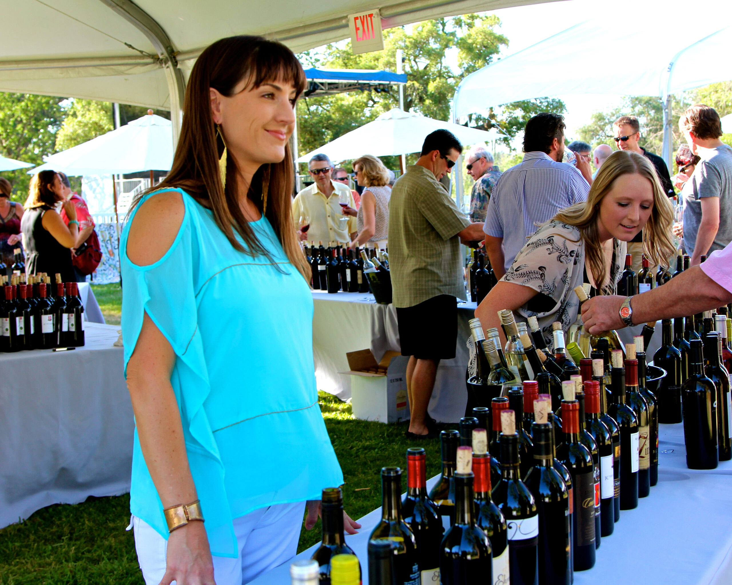 People tasting and purchasing wine at the Lodi Winegrape Commission outdoor event.
