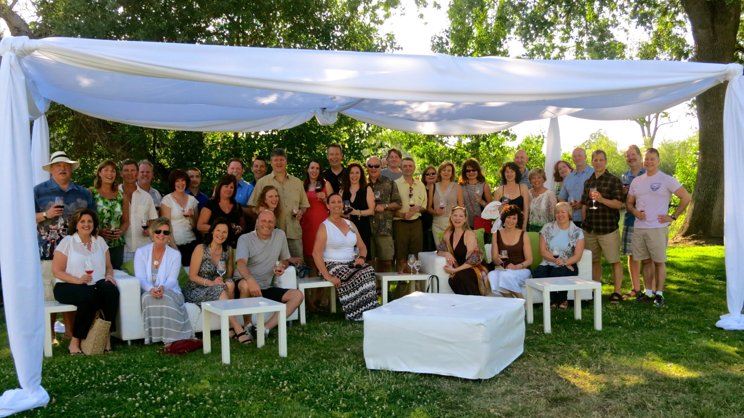 Group photo of Lodi Winegrape Commission members at outdoor event in lush green setting.