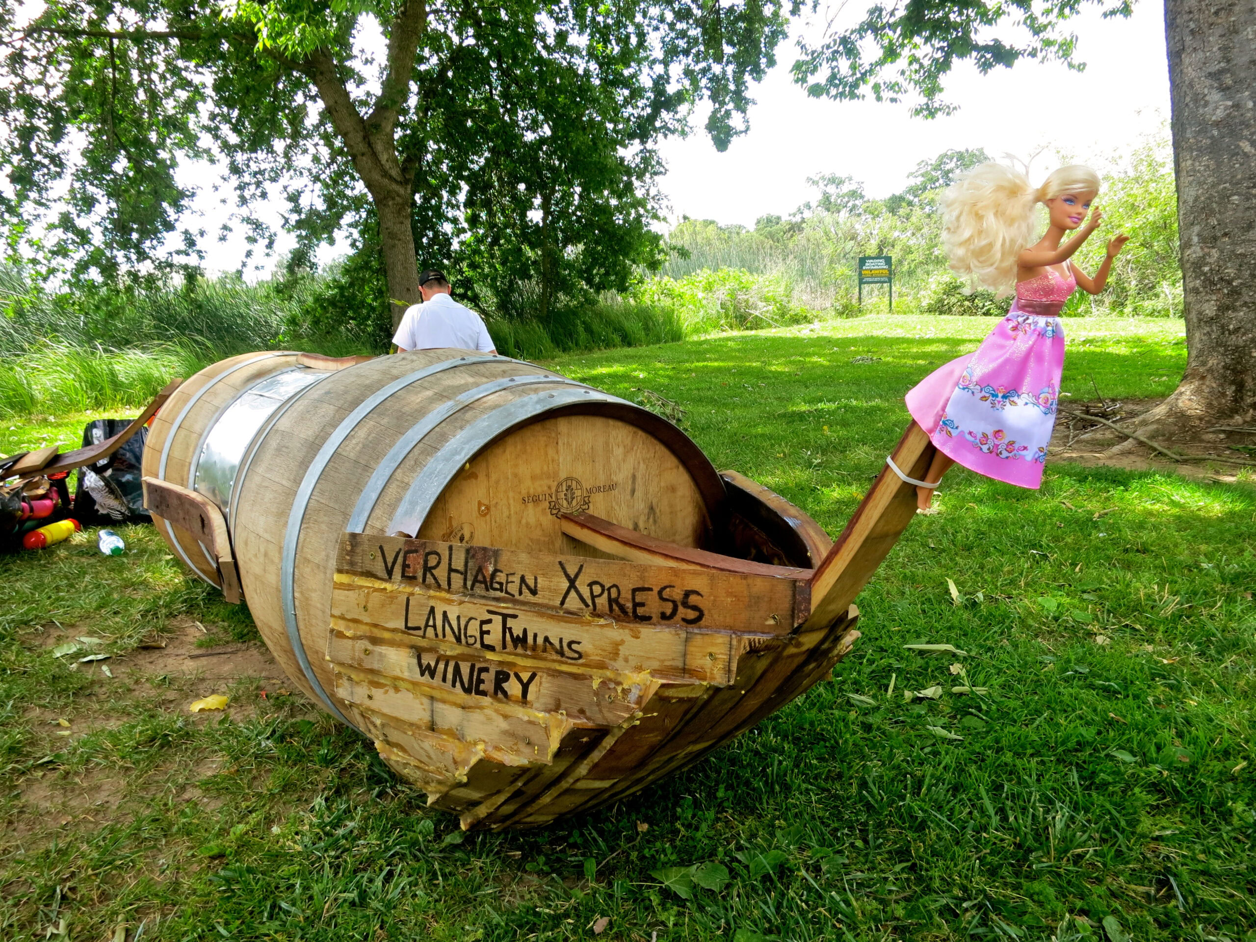 Whimsical scene with a doll on a barrel boat at Lodi Winegrape Commission vineyard.