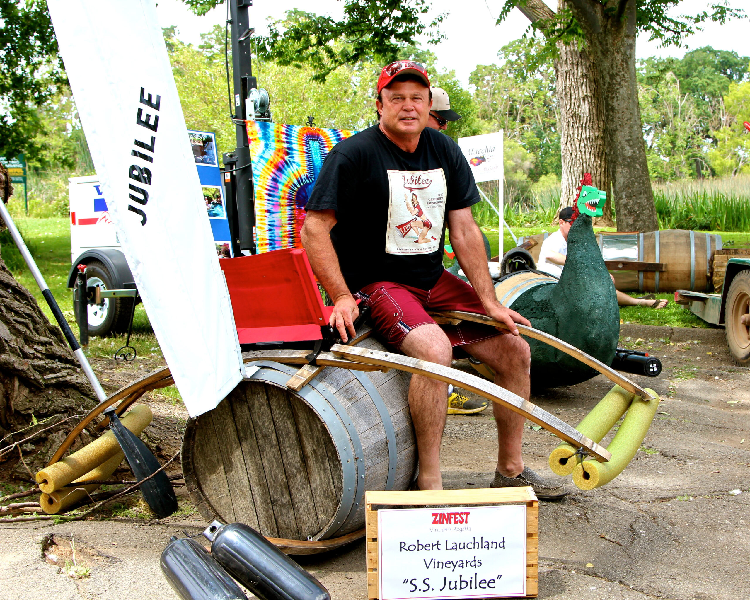 Man sitting on a barrel with a musical instrument at a wine event in Lodi, California.