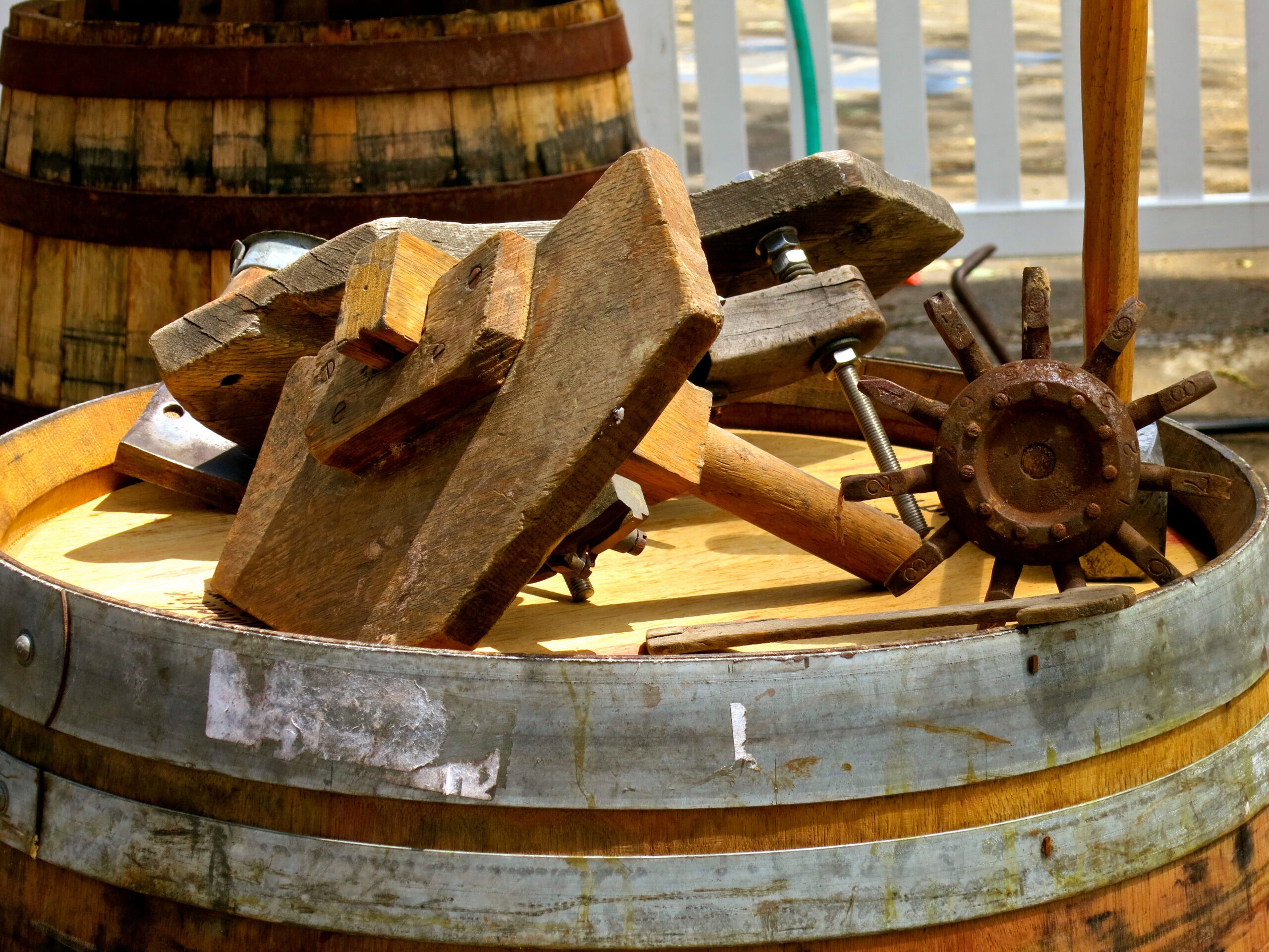 Vintage woodworking and ship wheel tools inside a wine barrel for Lodi Winegrape Commission.