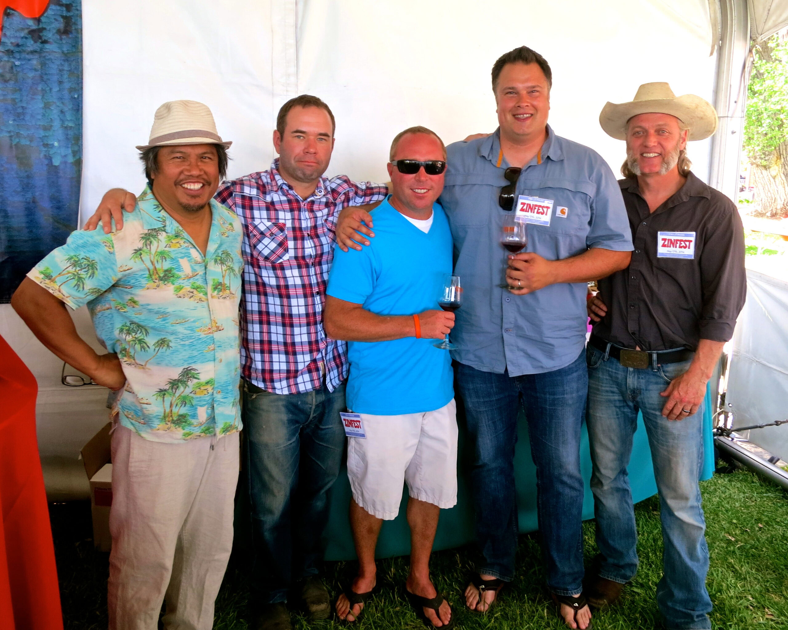 Group of men at Lodi Winegrape Commission event, smiling and holding wine glasses.