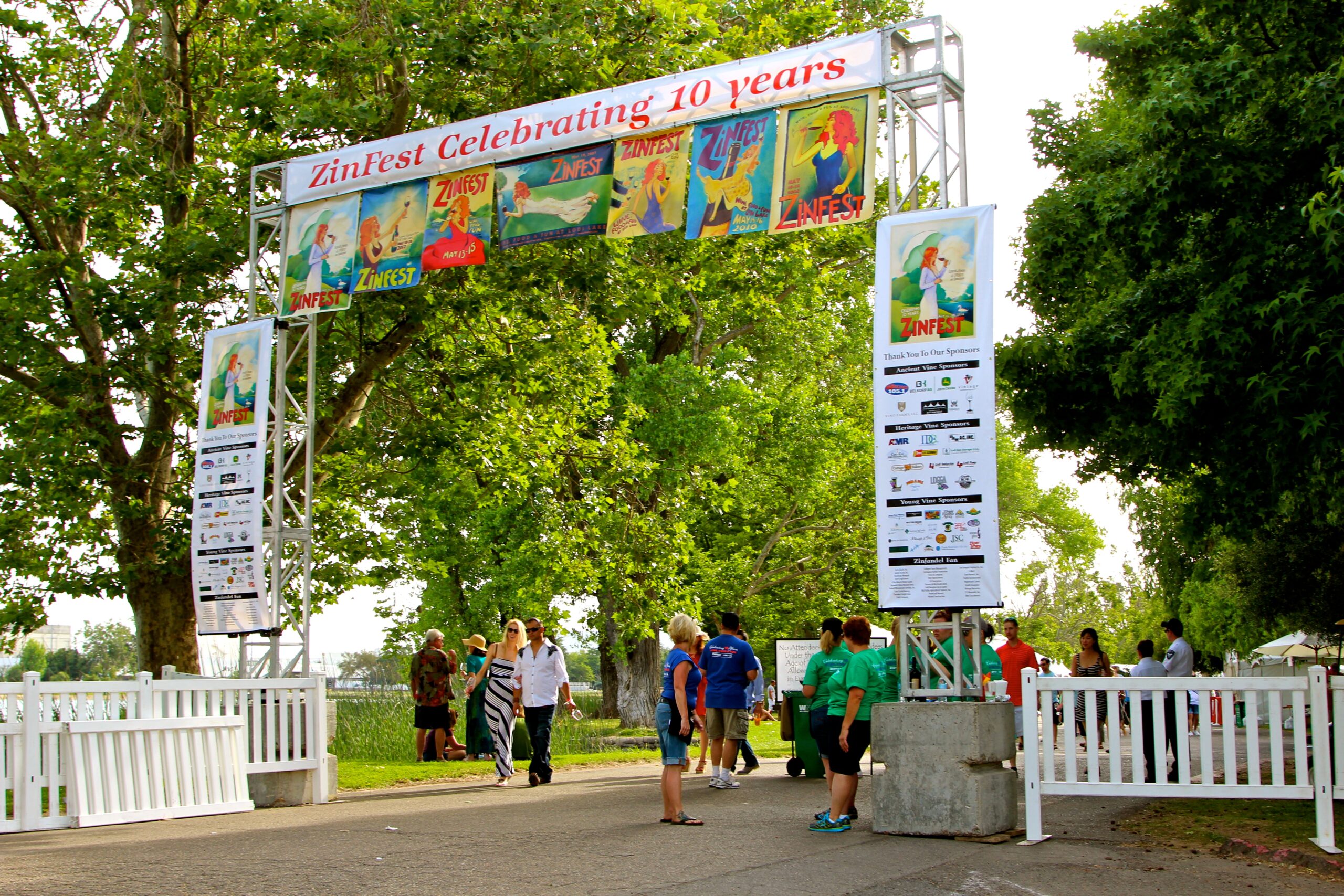 People attending Zinfest wine festival under a decorated archway in Lodi, California.