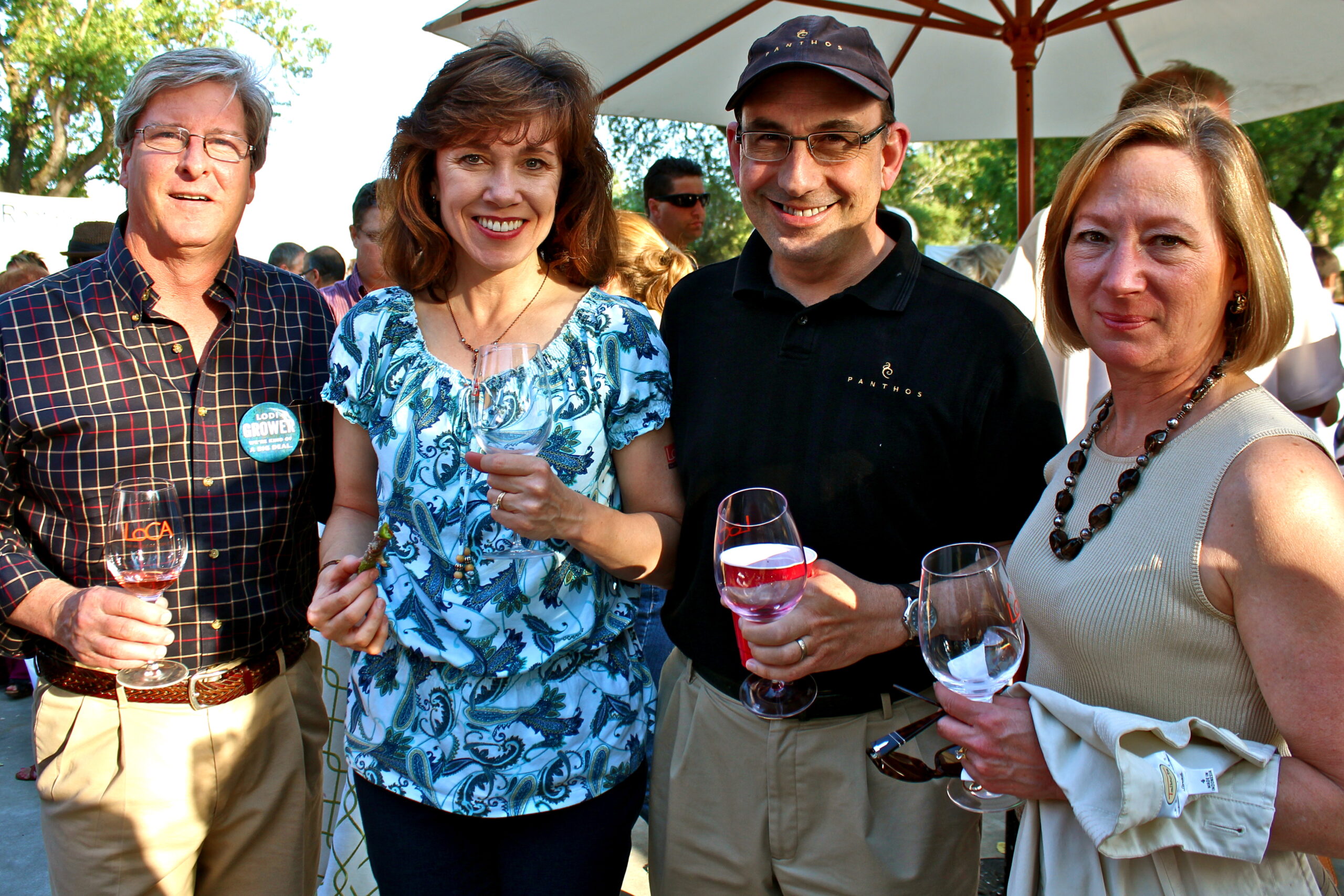 Group of people enjoying wine tasting at a Lodi wine event outdoors.