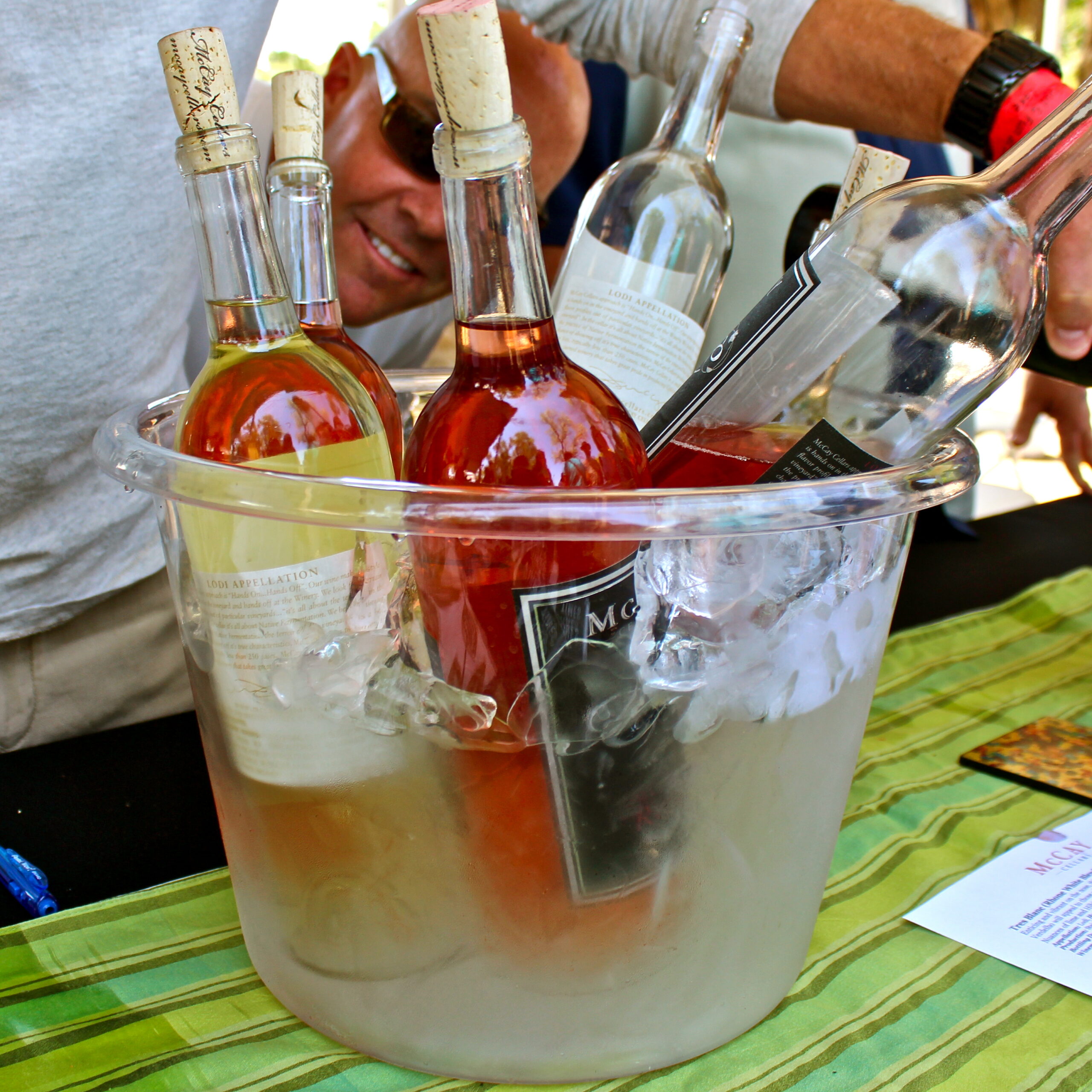 Bottles of wine in an ice bucket at a wine tasting event, showcasing Lodi wine region.