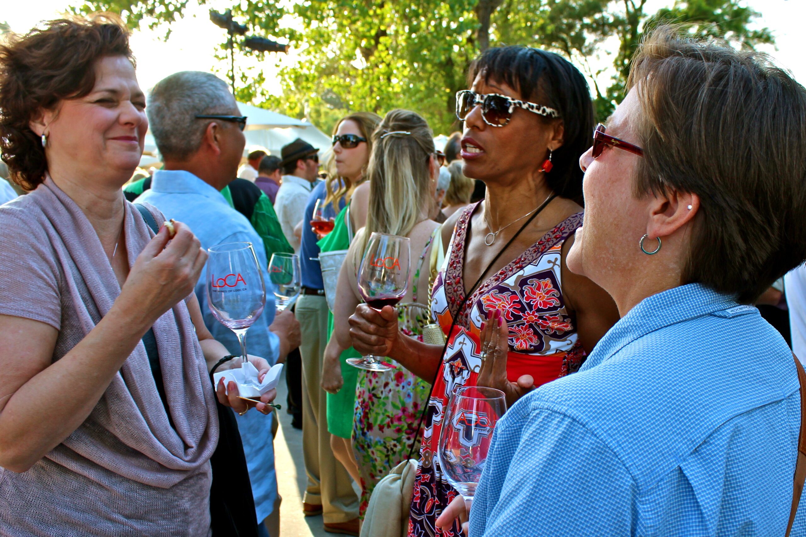 People enjoying wine tasting at a Lodi Winegrape Commission outdoor event.