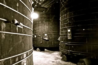 Large wine fermentation tanks at Lodi Winegrape Commission winery for premium wine production.