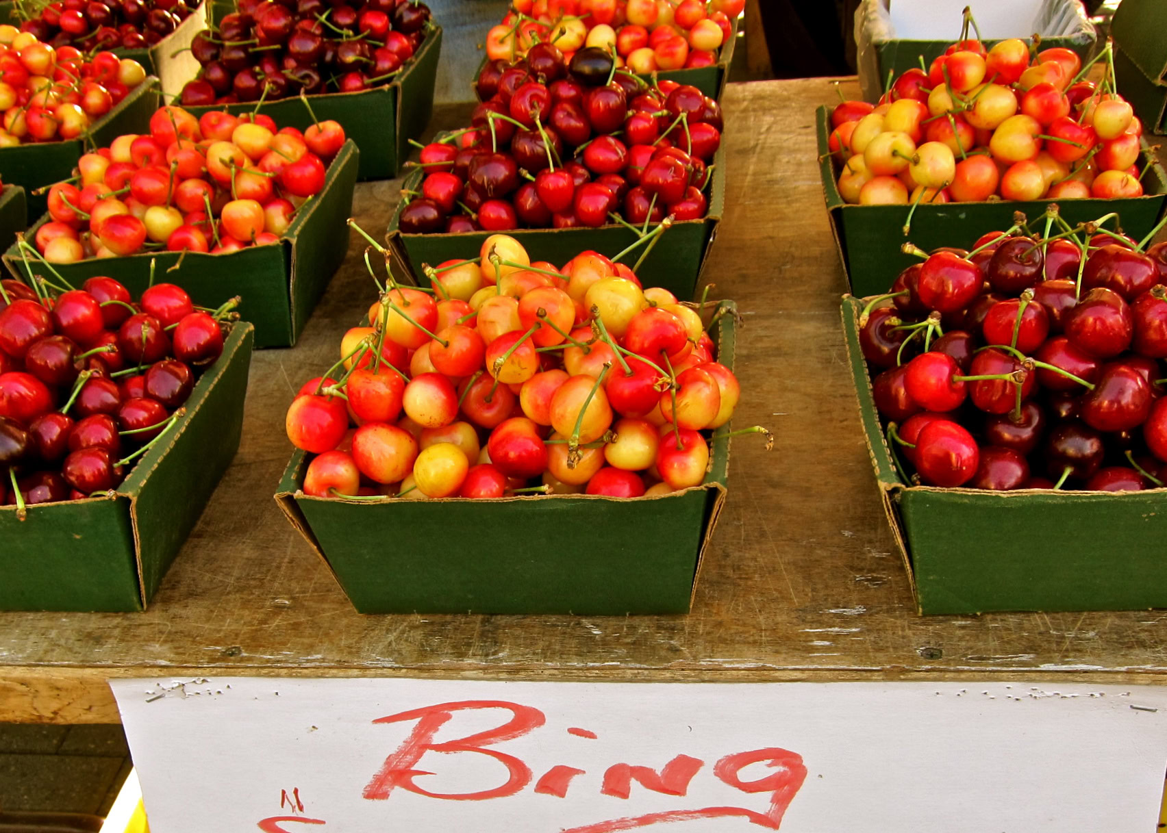 Fresh cherries in green bins at Lodi Winegrape Commission harvest event.