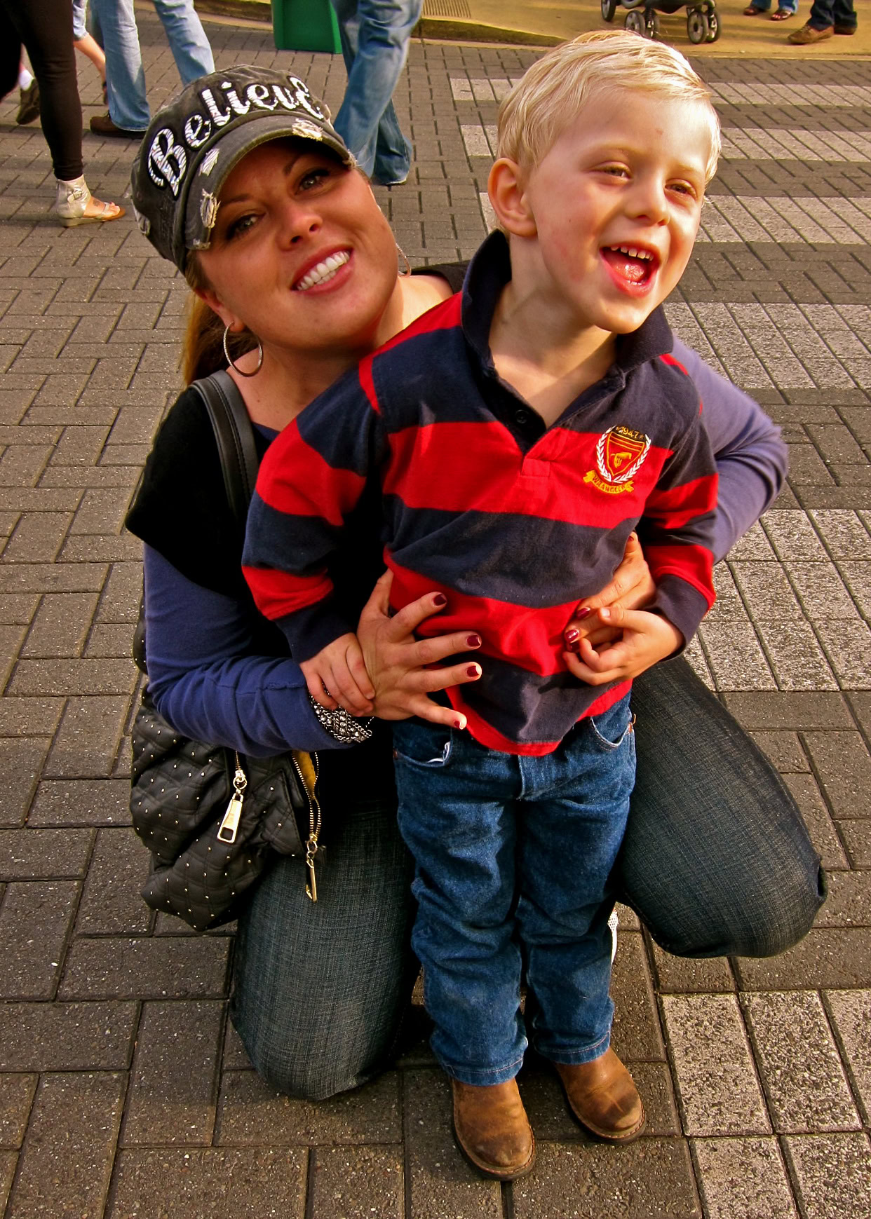 Smiling woman and young boy at Lodi Winegrape Commission event, enjoying outdoor activity and community gathering.
